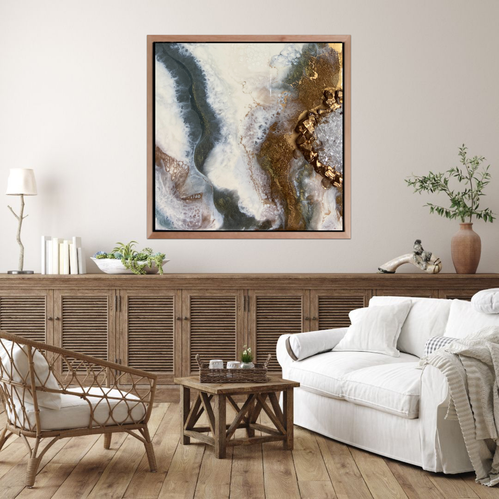 Living room with a framed abstract Tatyana Y. Kravchenko's art, white sofa with pillows, rattan chair, wooden coffee table, and decorative plants.