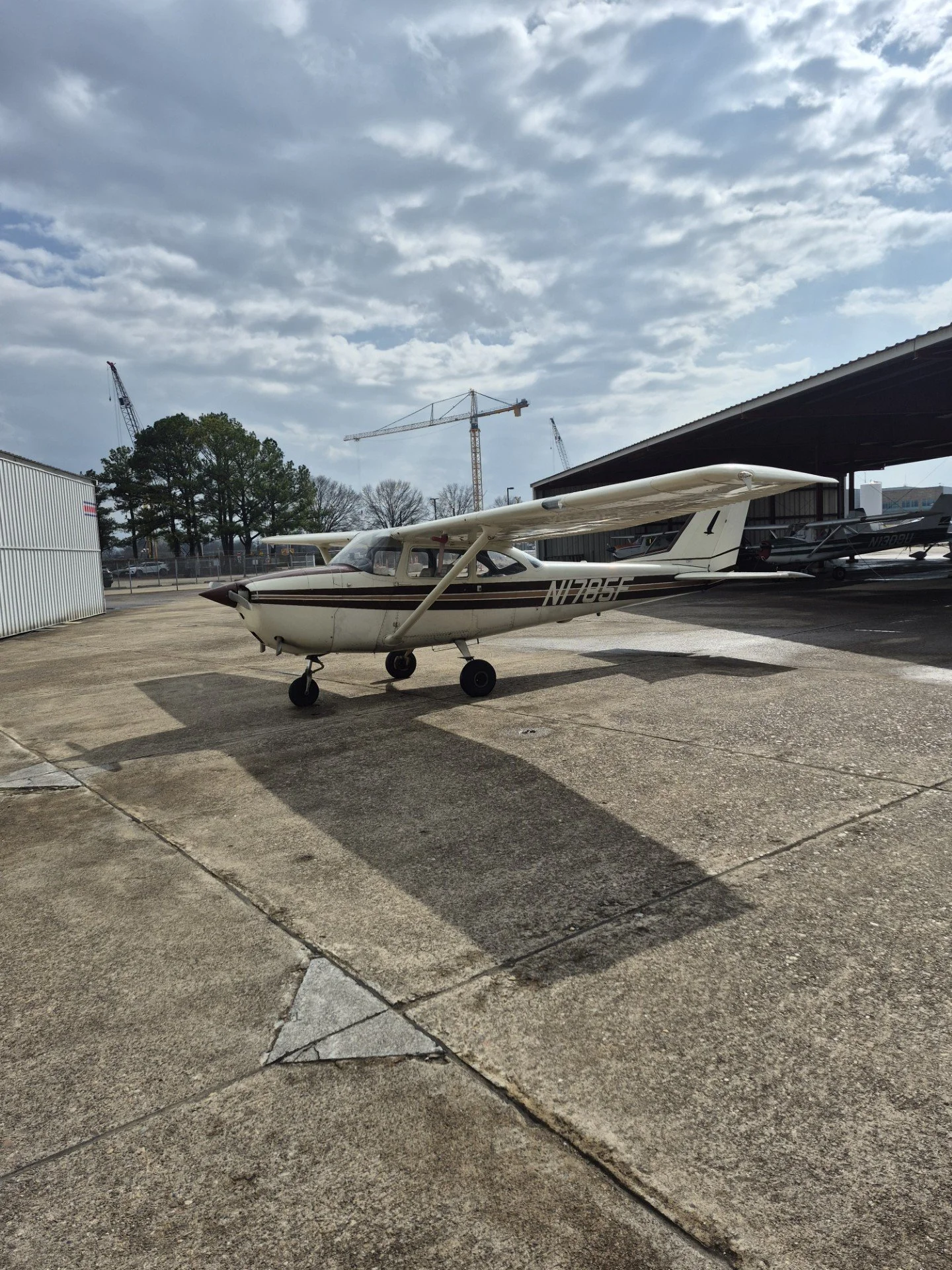 This picture shows a tan and brown Cessna 172 Skyhawk, sitting on the ramp at McGhee Tyson Airport