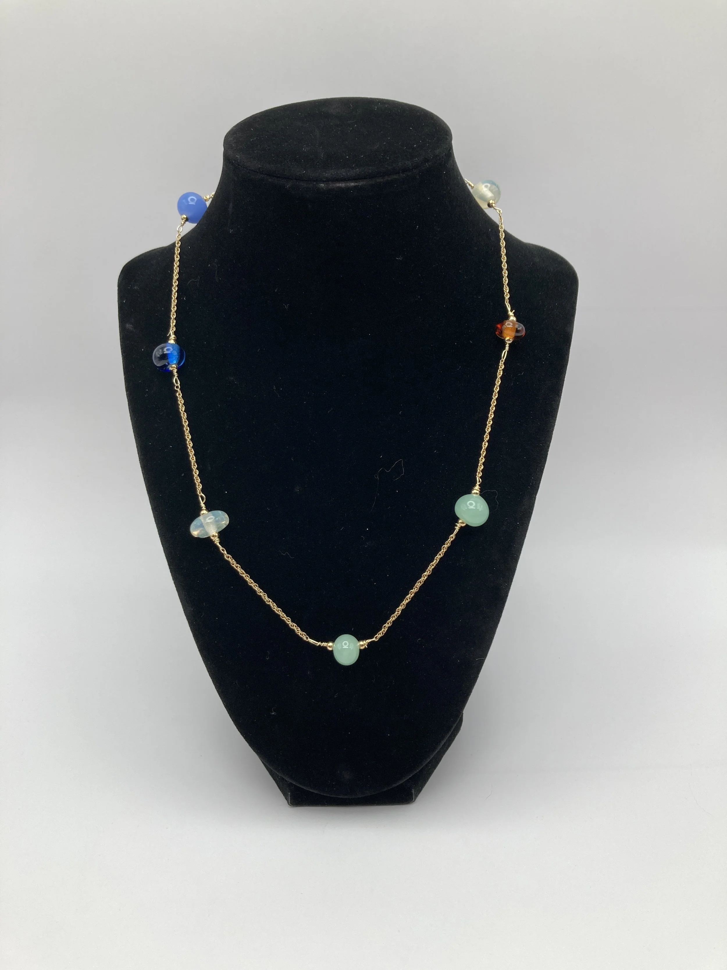 simple glass beads in variety of colors interspersed on gold chain