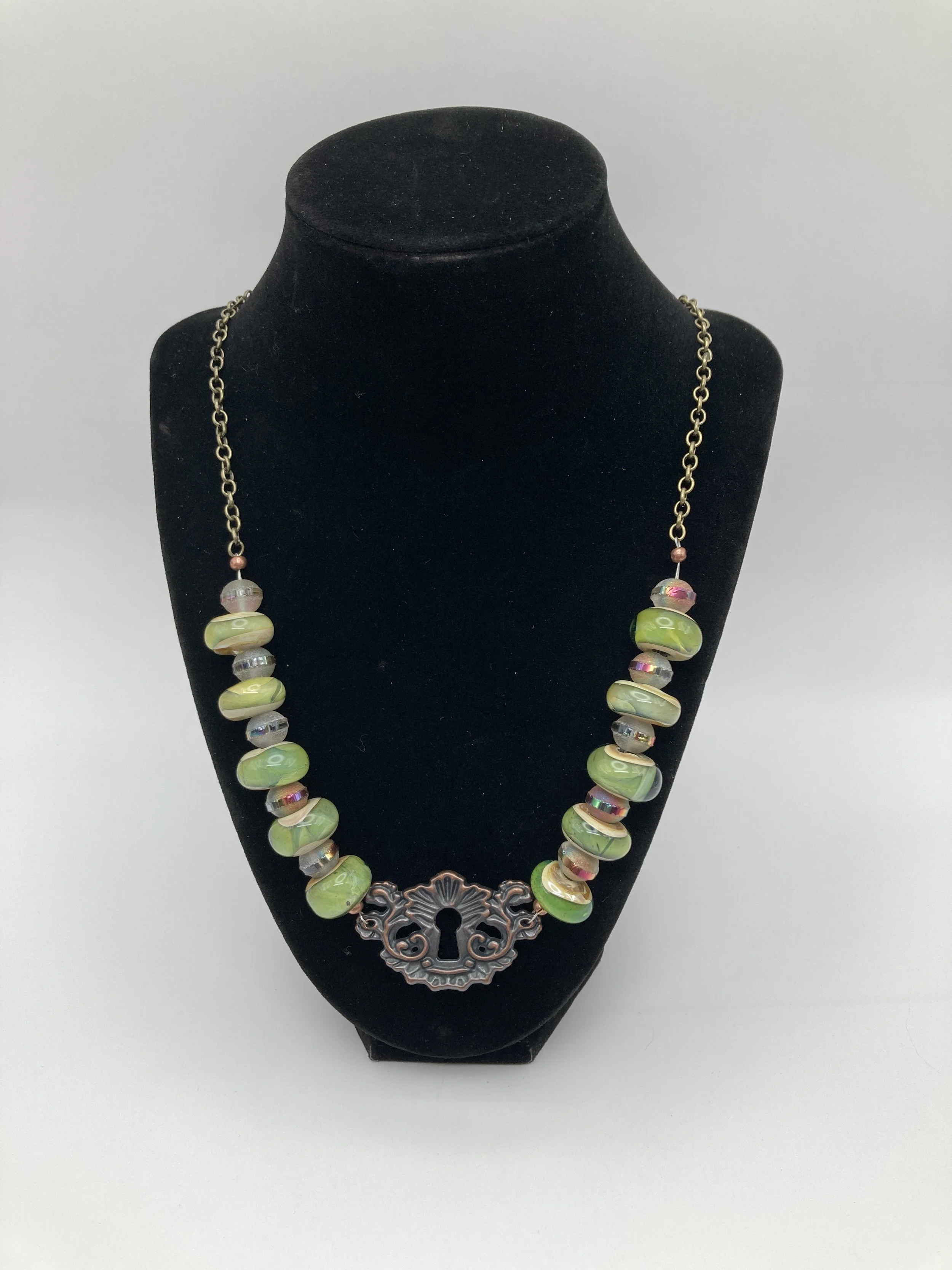 Necklace w multi colored green glass beads w focal keylock