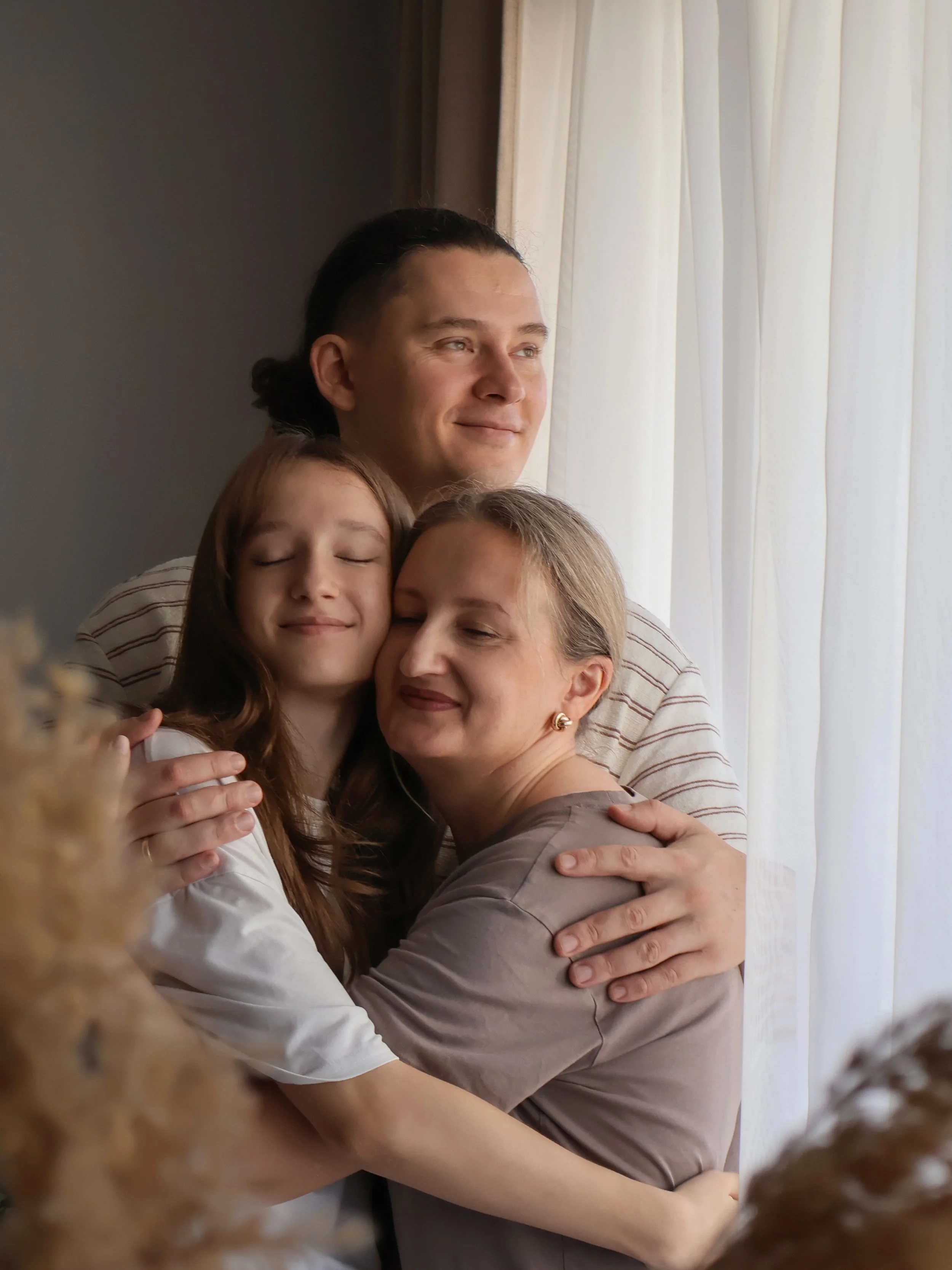 Picture of parents with their transgender child in therapy