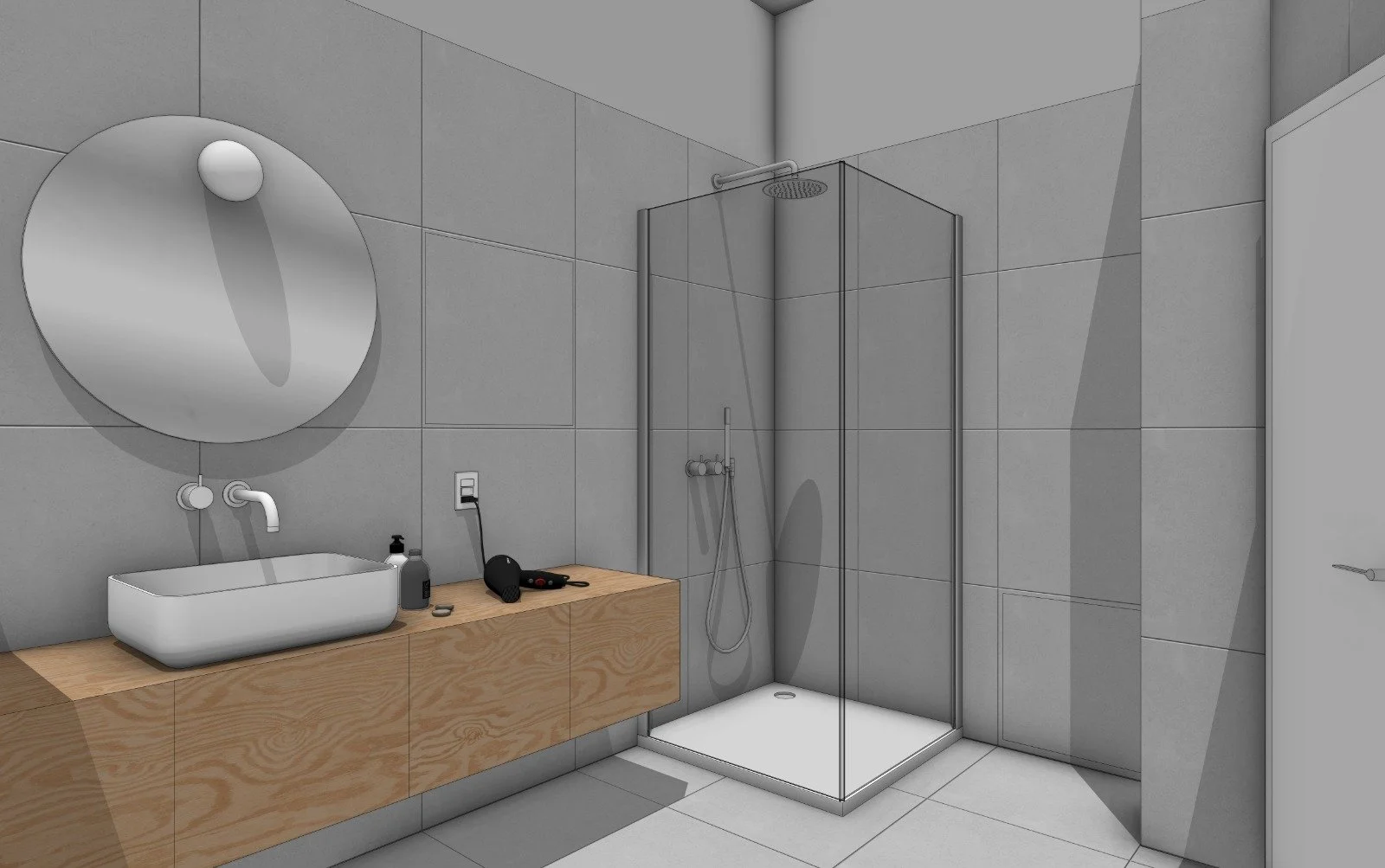 A modern bathroom with gray tiled walls, a wooden vanity with a white sink, a circular mirror, black soap bottles, and toiletries on the counter. It features a glass-enclosed shower area with a rainfall showerhead and a handheld shower. There is an electrical outlet near the vanity.
