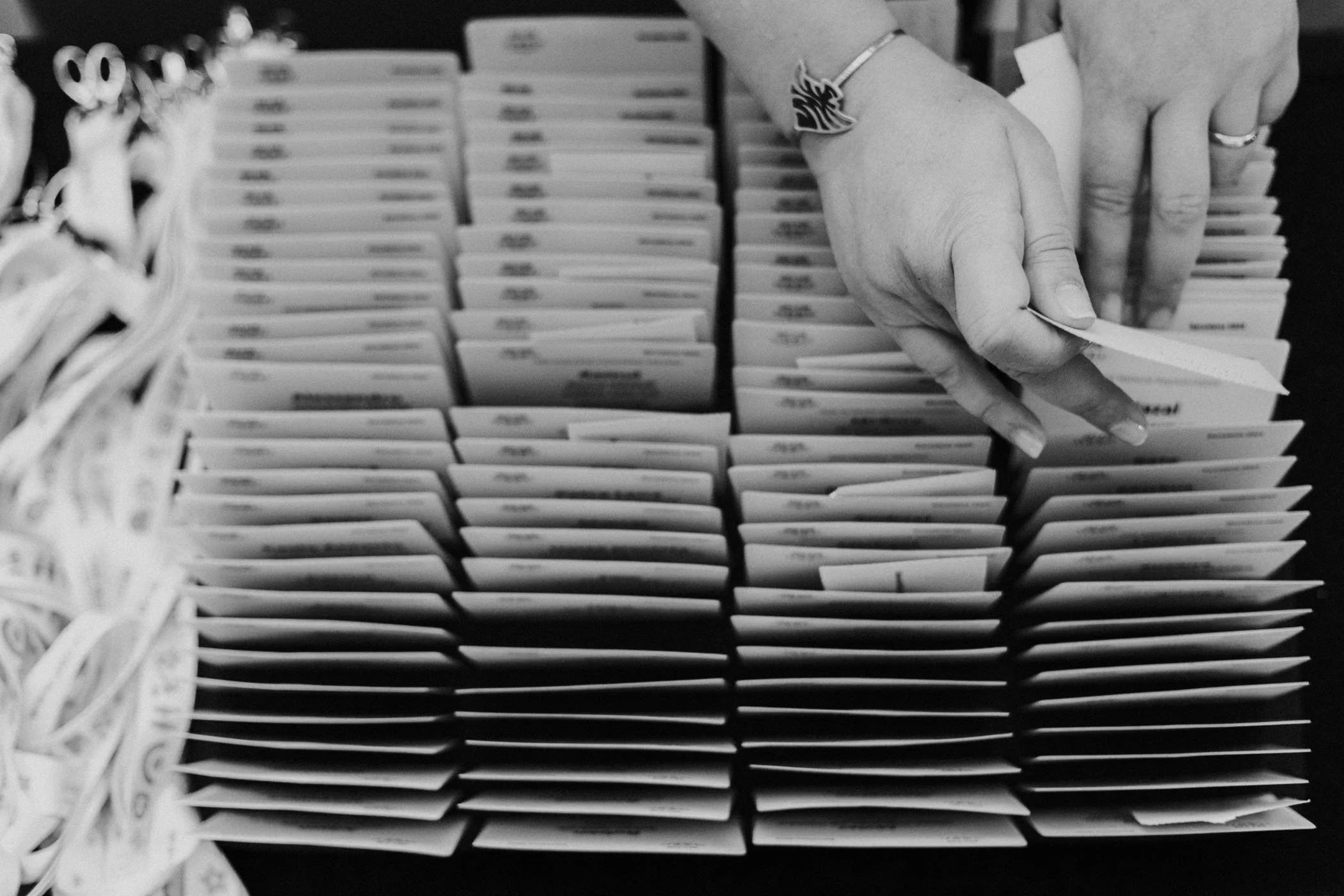 Mano revisando tarjetas o papeles en una bandeja