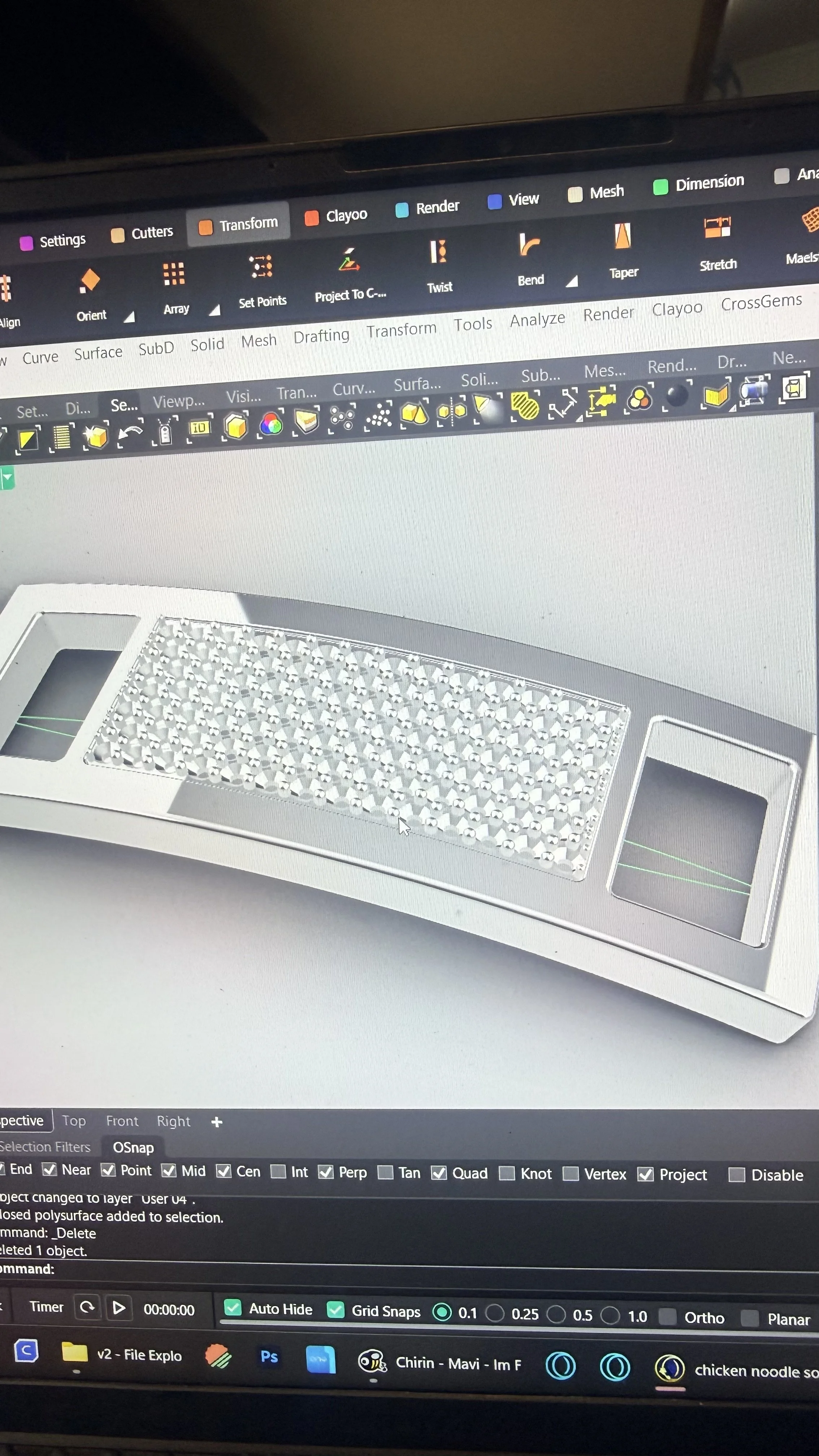 Computer screen displaying 3D modeling software with a detailed 3D model of a jewelry piece or decorative object, featuring a grid of stones or crystals.