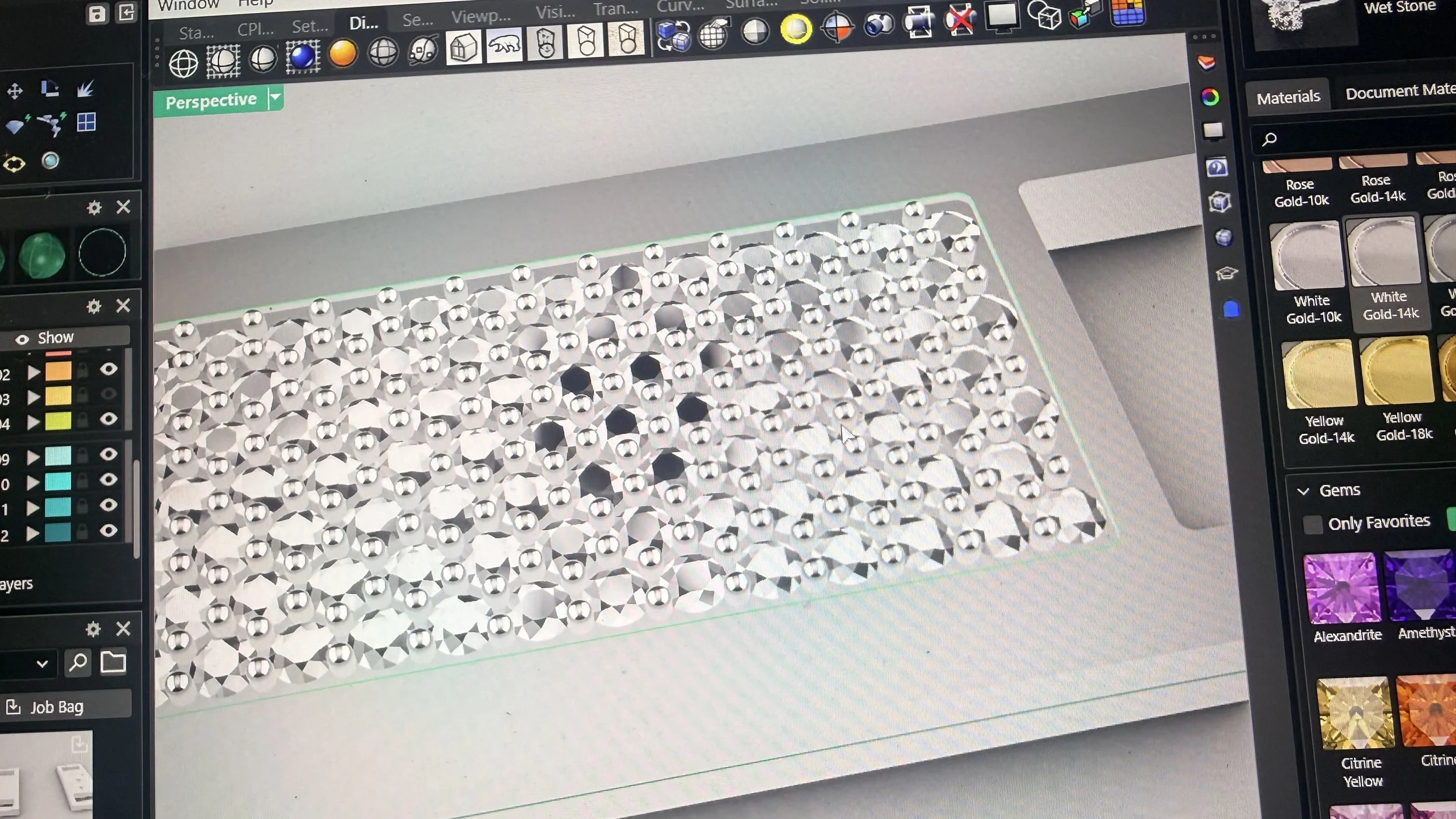 Computer screen displaying a 3D modeling software with numerous diamond-like gems arranged in a grid, with a sidebar showing different material options such as gold, white, yellow, and gem colors.
