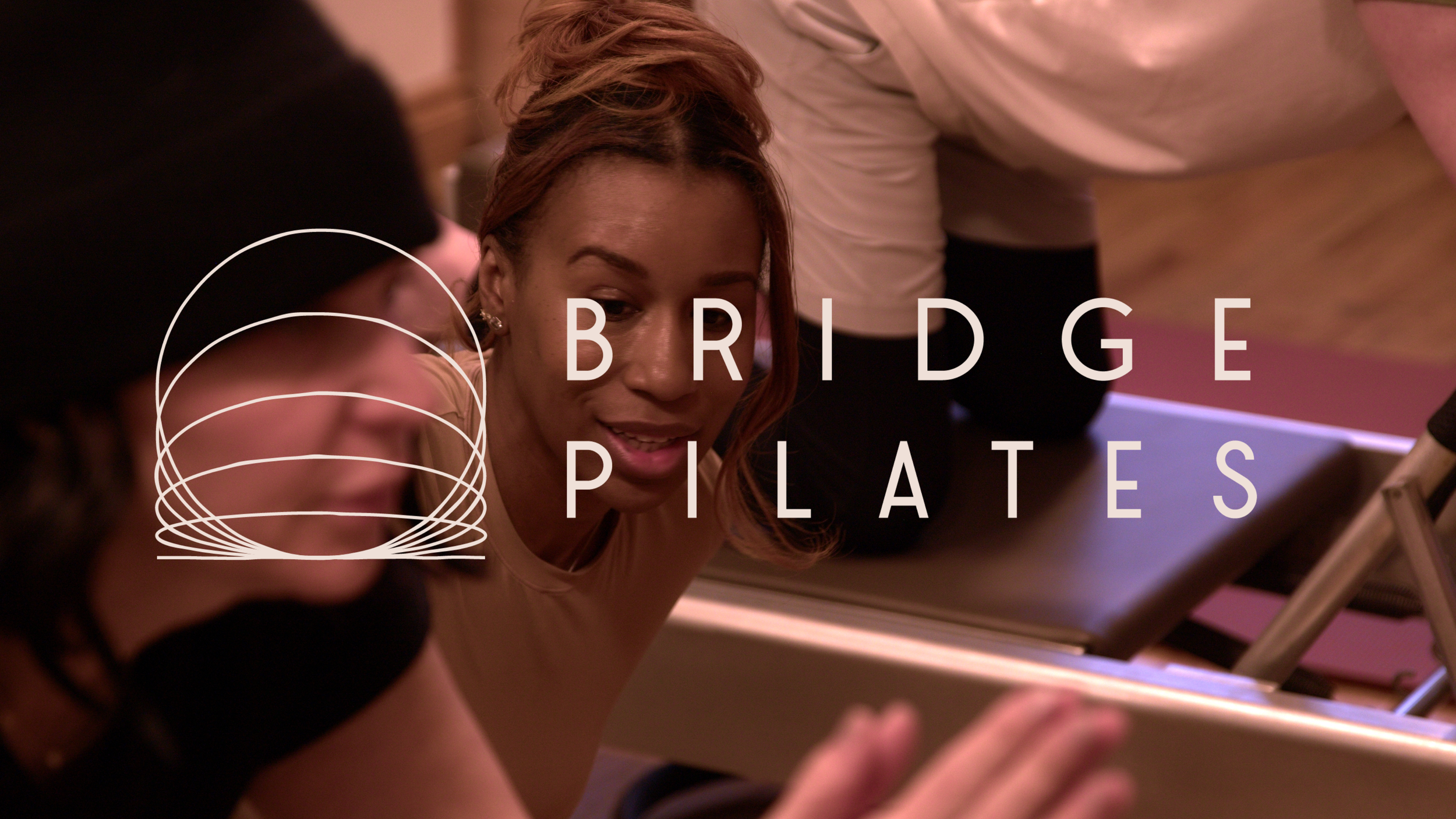 A woman doing a Pilates exercise lying on a reformer machine, with another person assisting her. Text overlay reads "Bridge Pilates" and features a graphic of a spiral.