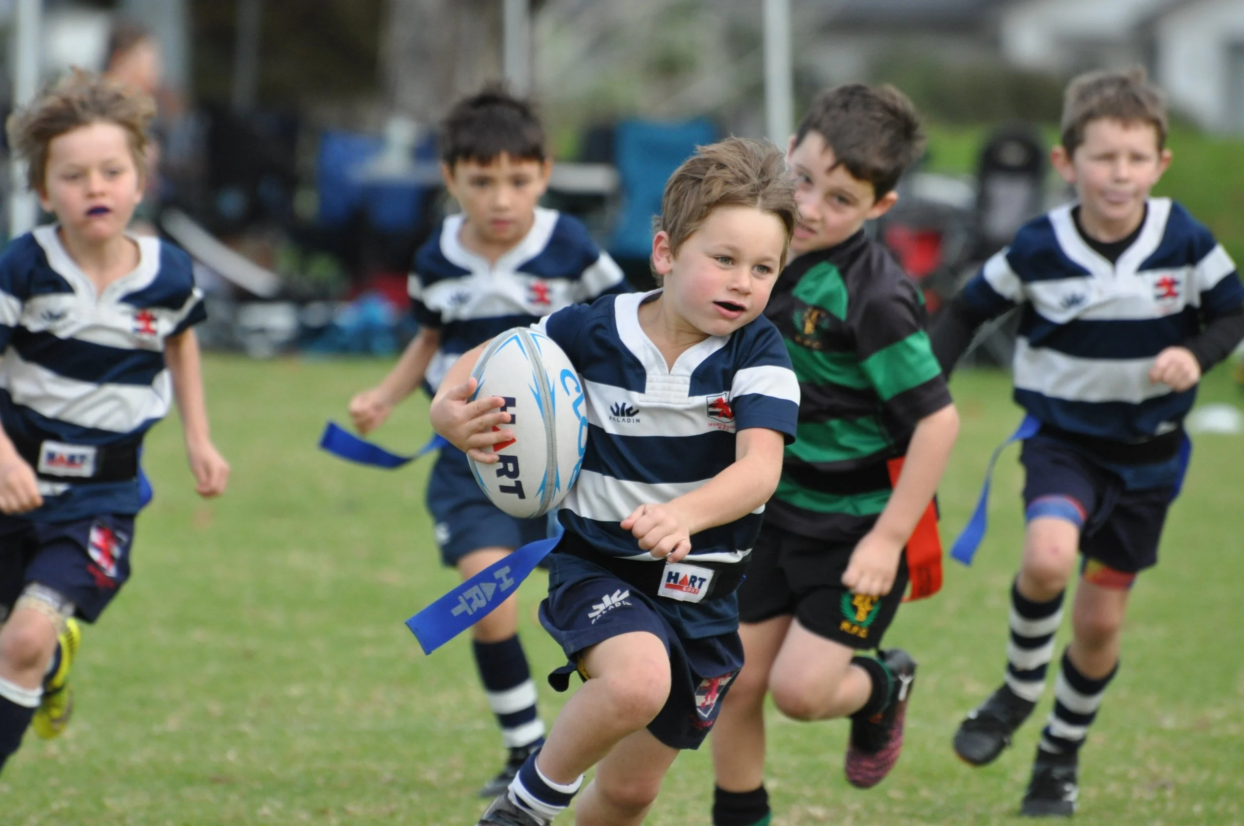 Canterbury festival - young boy running with rugby ball