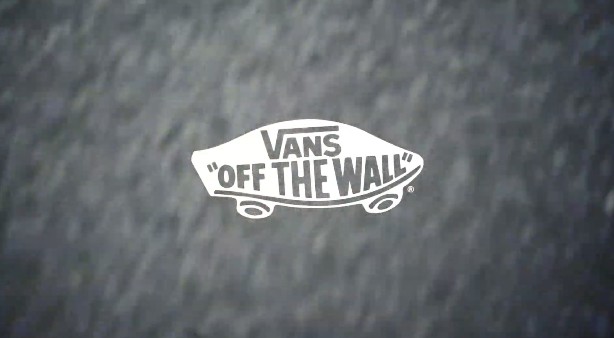 Gray fabric material with Vans logo and the slogan 'Off the Wall' in white.