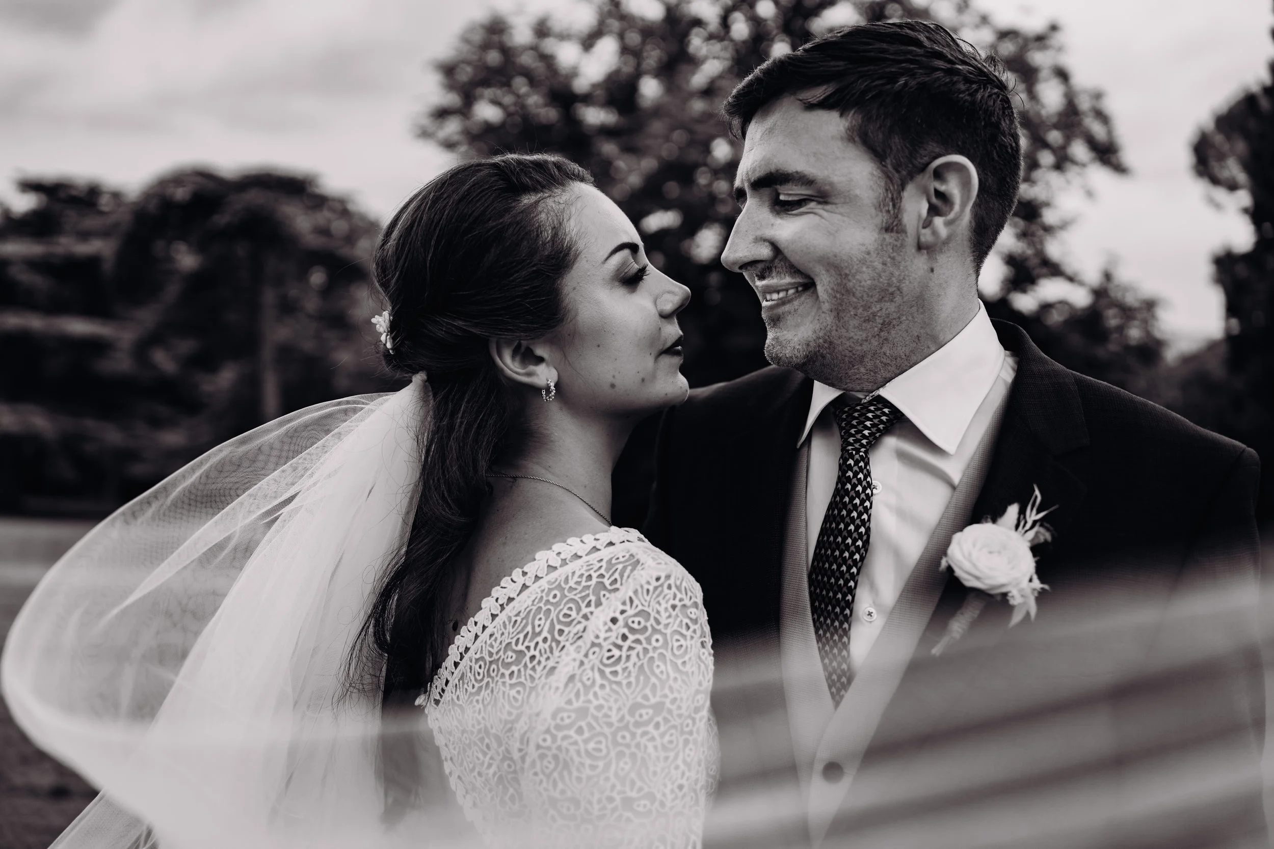 Le voile de la mariée s'envole devant lors d'une photo de couple de mariage au domaine de Gailhaguet près de Toulouse, en Occitanie. 
