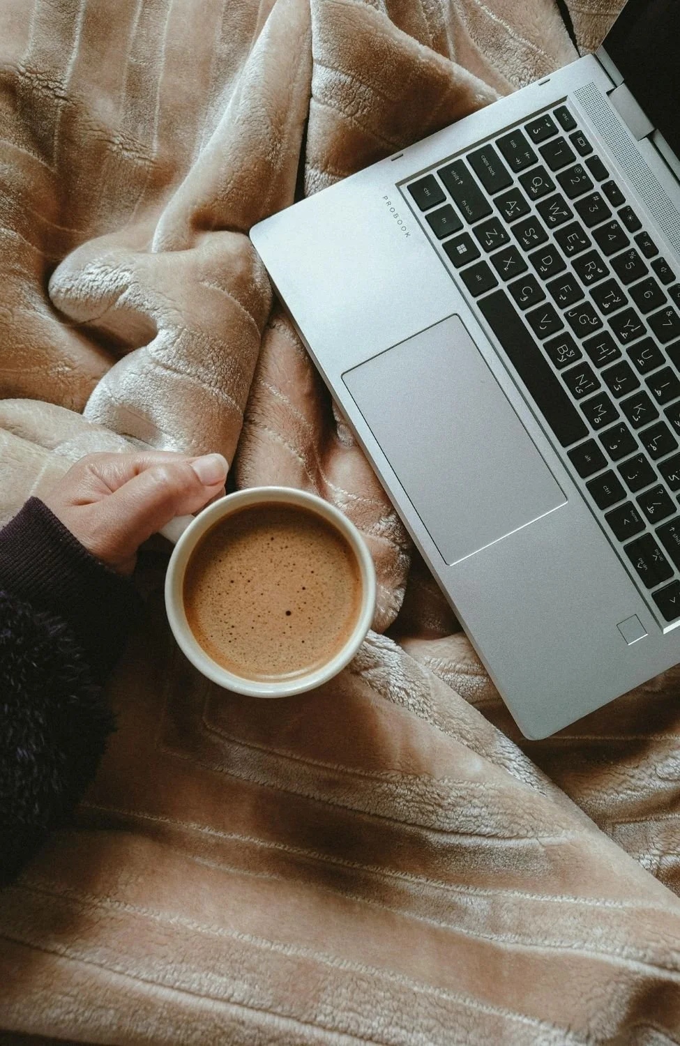 A laptop, coffee, and notebook all used during  integrative psychotherapy and counselling in burnaby