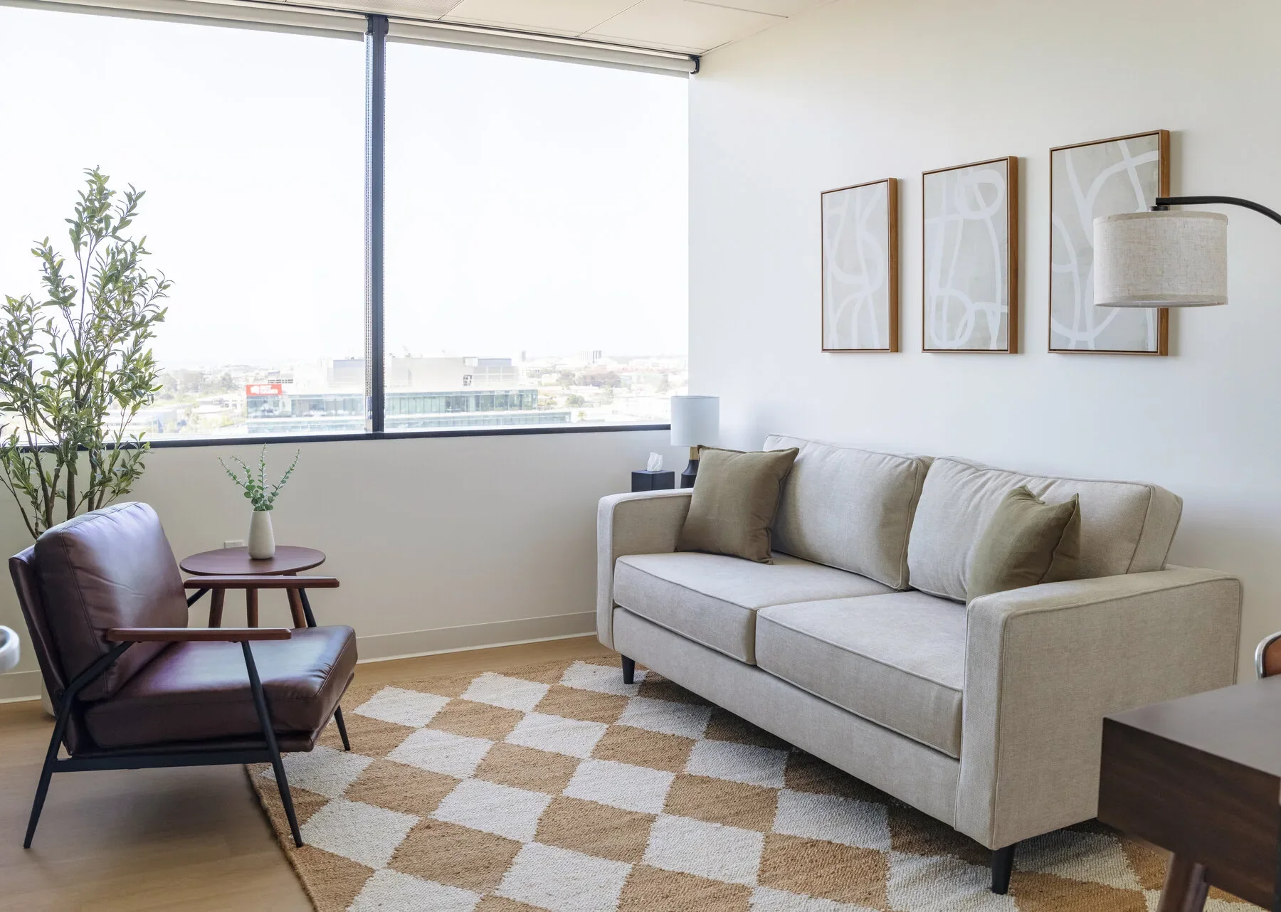 Therapy office in West Los Angeles with neutral sofa and city view