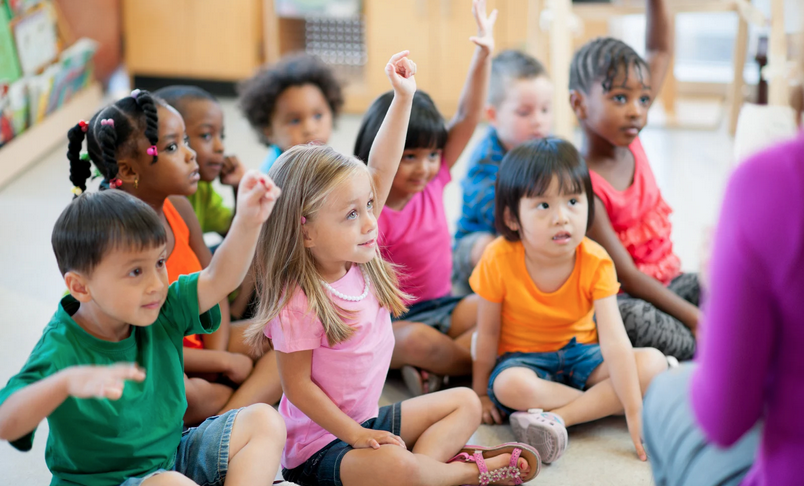 Preschool kids raising their hands
