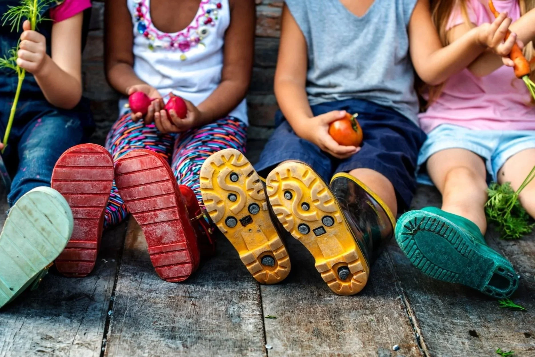 row of kids in rainboots