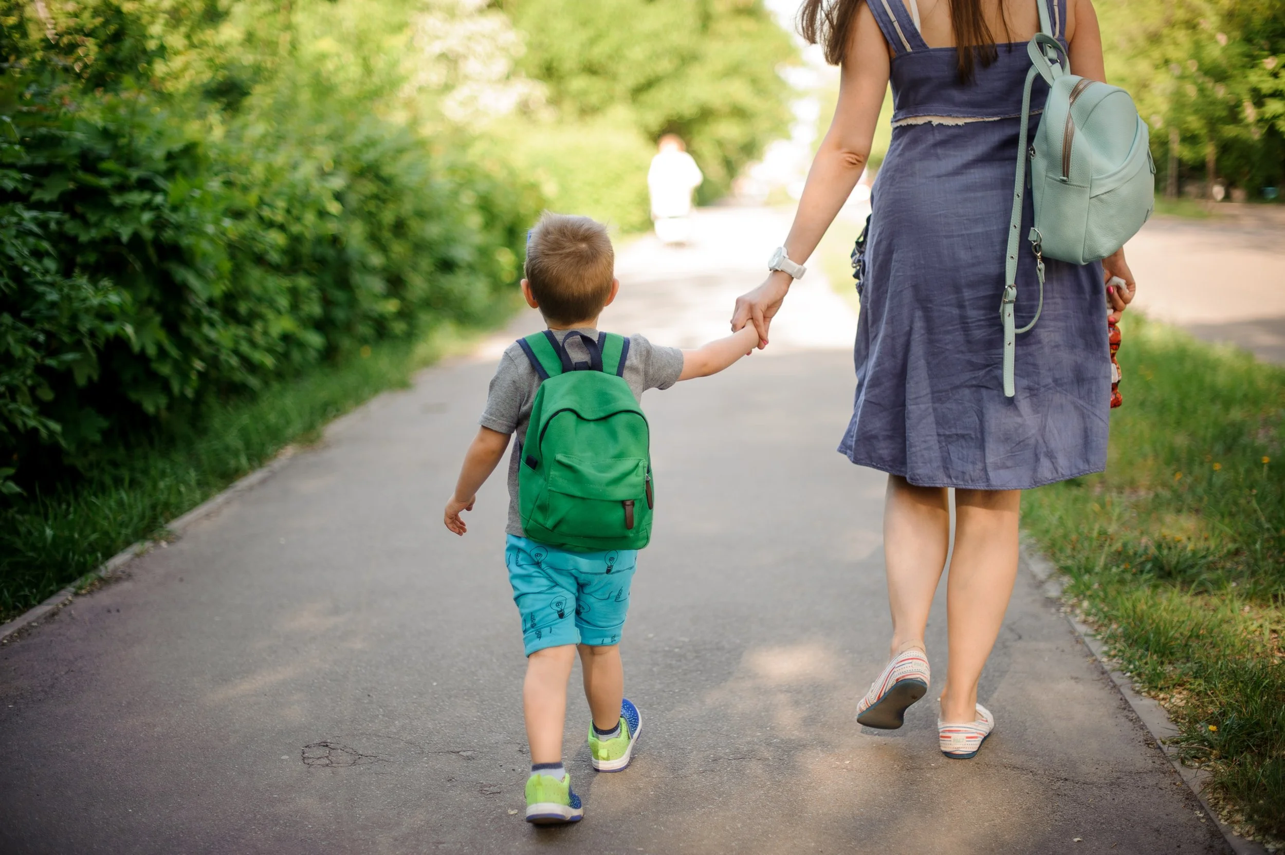 pre- k kid holding moms hand