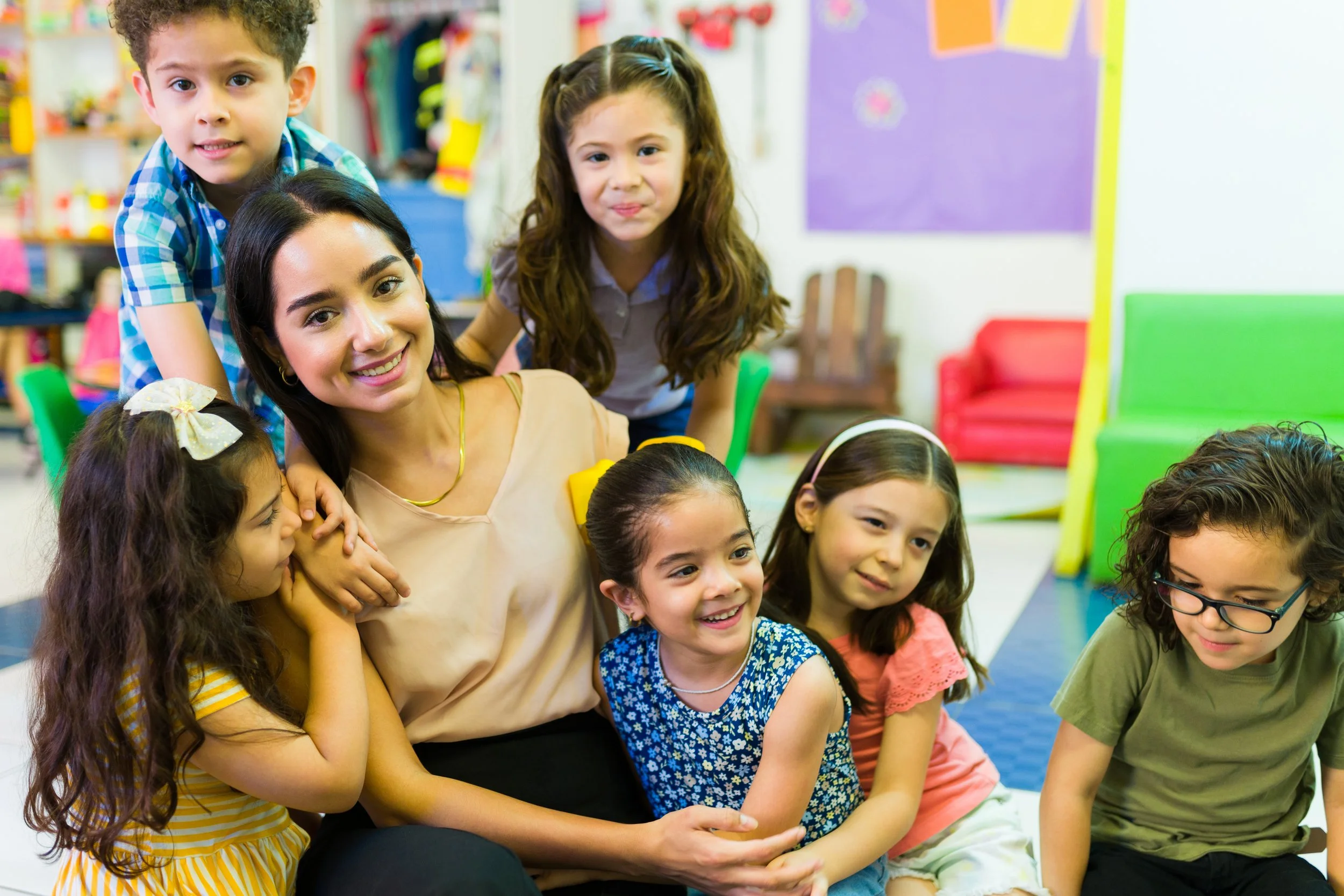 Teacher surrounded by young students