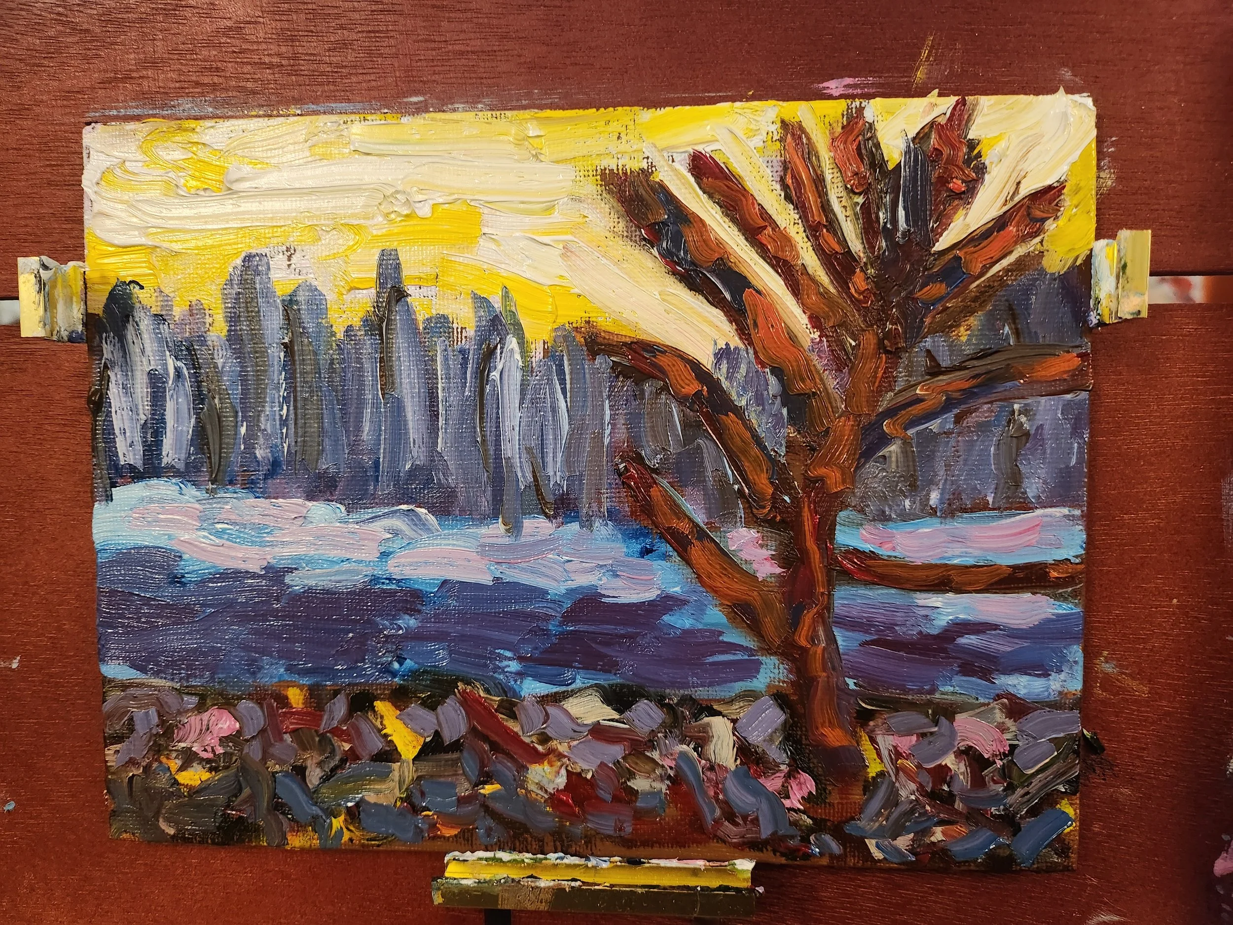An abstract impressionist oil painting of a sunset over a river with a large leafless tree in the foreground and a line of tall trees in the background.