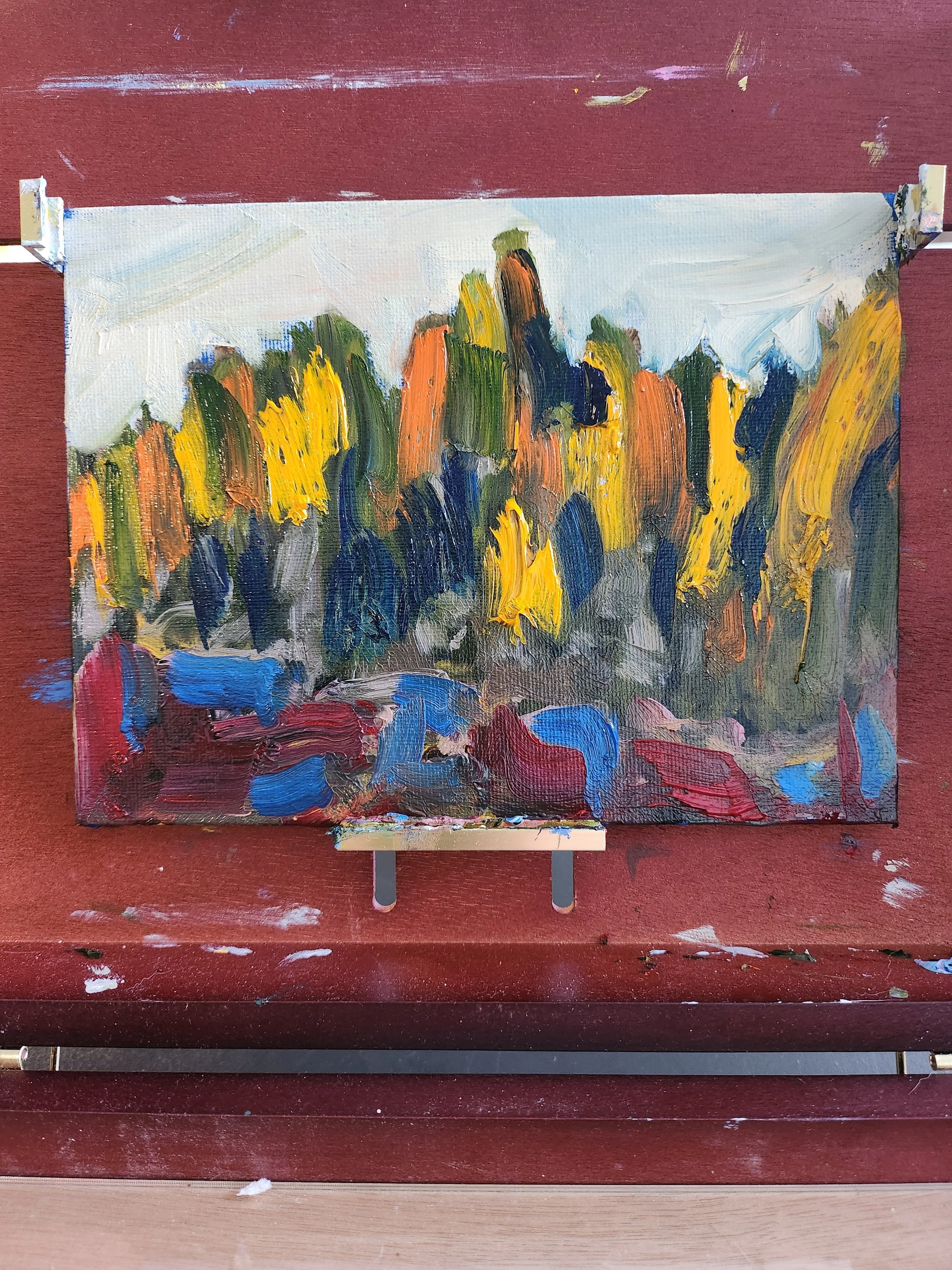 An abstract impressionist landscape oil painting with colorful trees in yellow, orange, green, and blue, set against a light sky, with darker colors at the base. This is of a scene in the boreal forest on the Canadian shield.