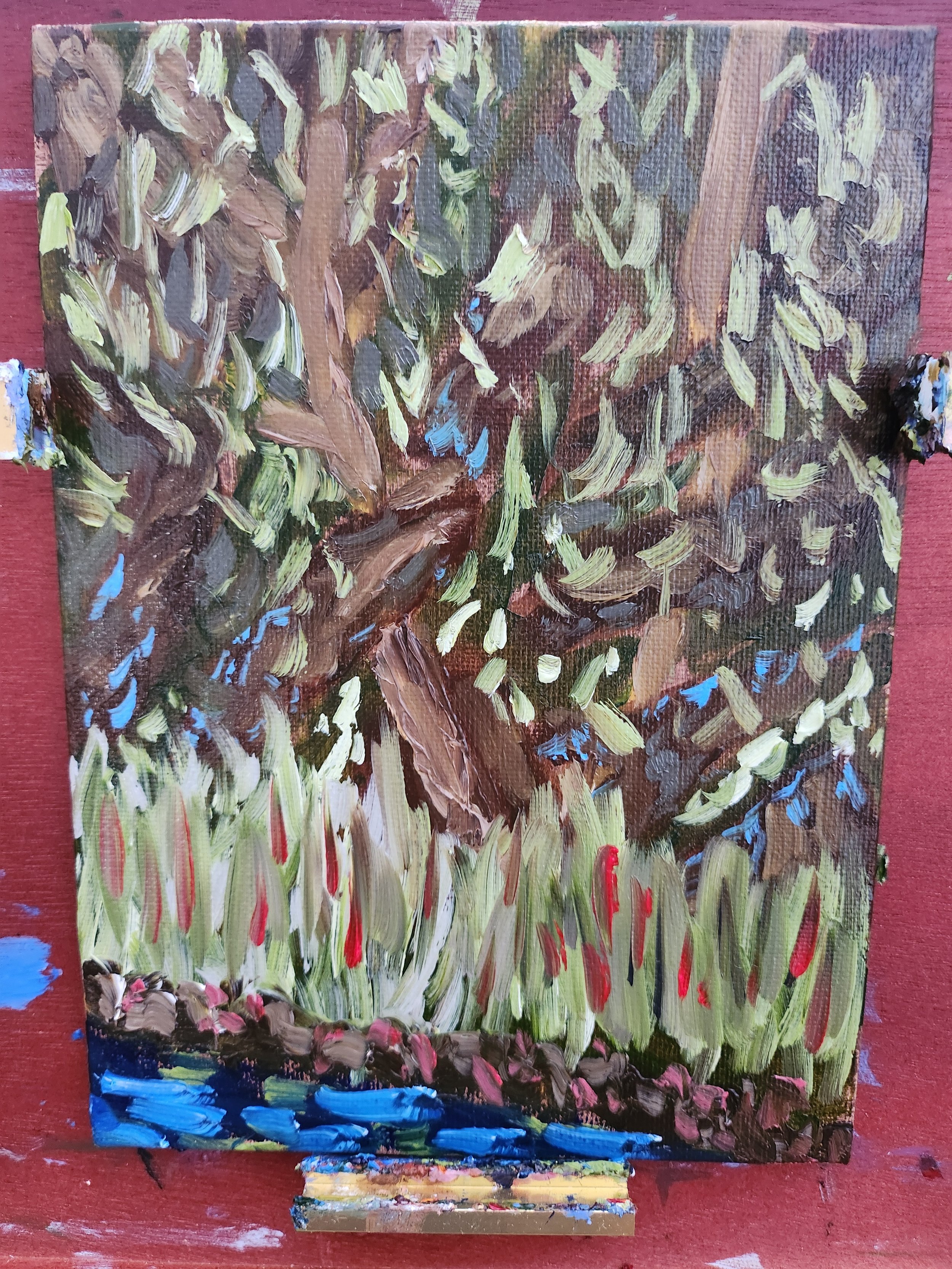 An abstract impressionist oil painting of a tree with broad brushstrokes, green and brown foliage, a trunk, and red and green plants at its base, on a red background.