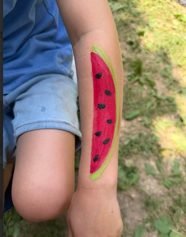 watermelon using facepaint on a childs arm