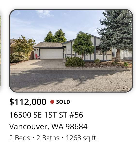 Photo of a single-story house with a two-car garage, surrounded by trees and shrubs, situated on a paved street , marketed and sold by realtor Kelly Craig Graham in Vancouver, Washington.