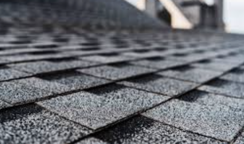 Close-up of a shingled roof with dark asphalt shingles.