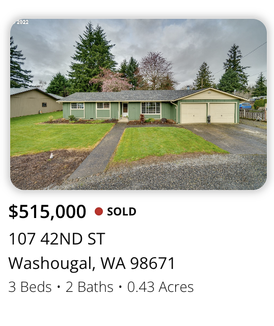 Front view of a single-story house with green exterior paint, attached garage, well-maintained lawn, and driveway, surrounded by trees.