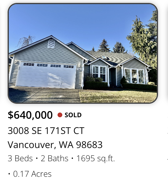 Front view of a light blue, single-family house with a two-car garage, located in Vancouver, Washington. The house has three bedrooms, two bathrooms, and is on a .17-acre lot, listed for $640,000.