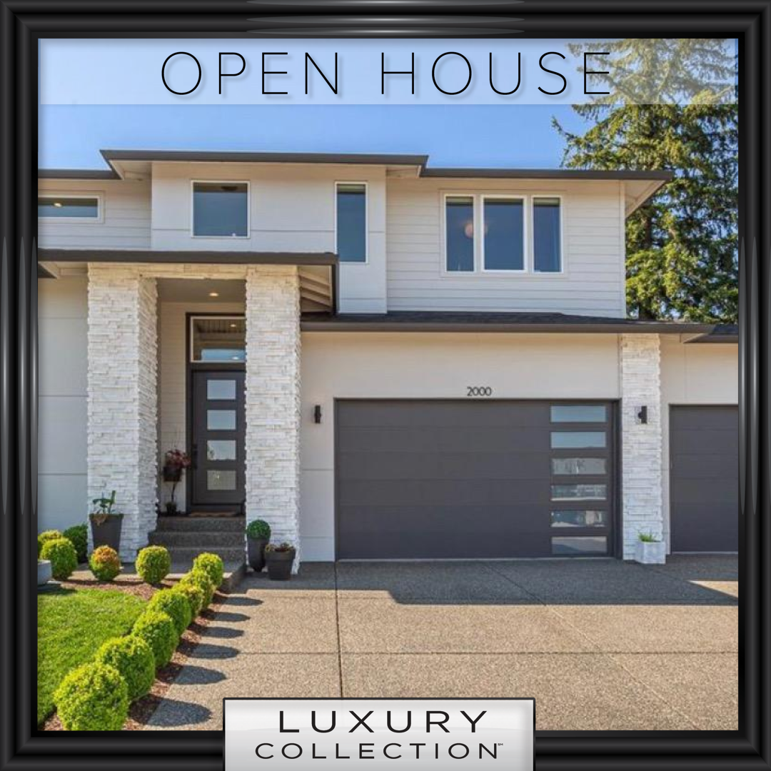 A modern two-story Washougal house with white siding, stone columns, and dark gray garage door, sold by realtor Kelly Craig Graham.