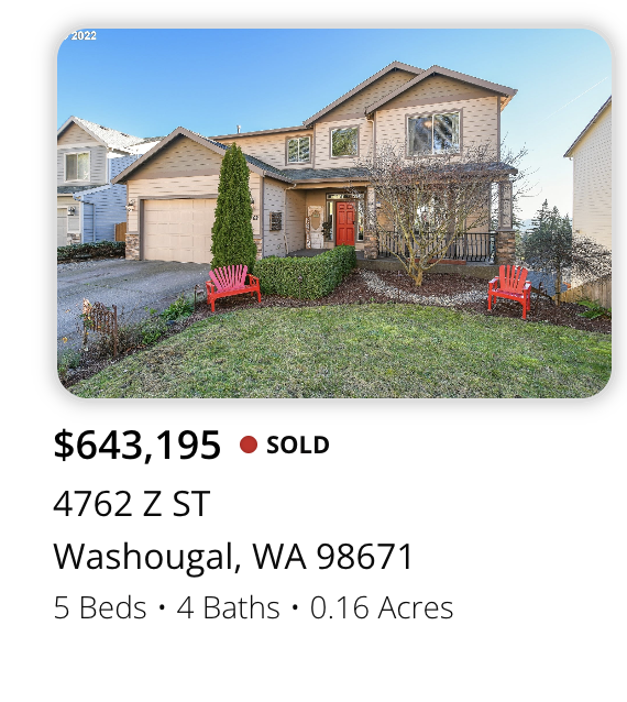 Front view of a two-story house with a red front door, two red benches in lawn, and a small garden with trees and bushes, located in Washougal, Washington.