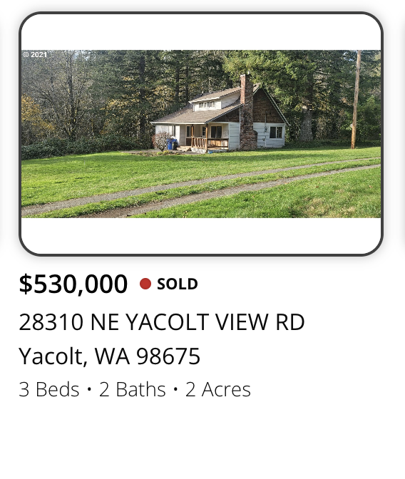 Photo of a suburban house with a brick chimney, white siding, and a front porch surrounded by a large grassy yard and trees.