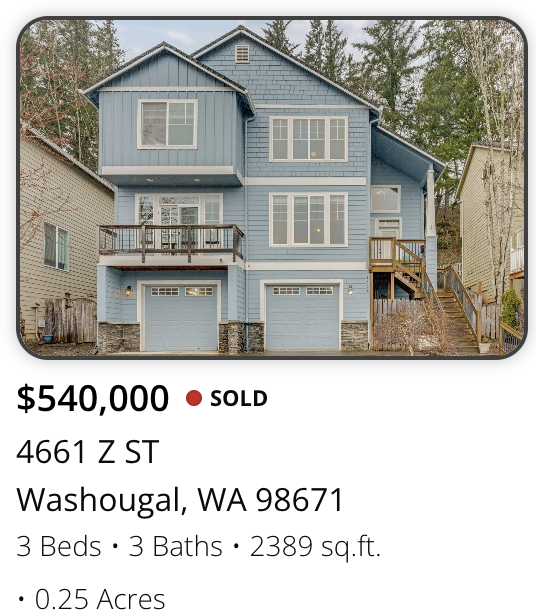 Blue multi-story house with garage, balconies, and stairs in Washougal, Washington.