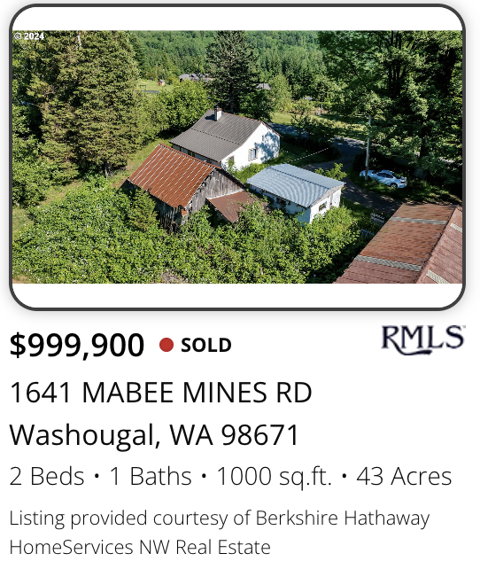 A large acreage property marketed and sold by realtor Kelly Craig Graham with aerial view of a property with a white house, a rusty shed, and surrounding greenery and trees in a rural area of Washougal, Washington