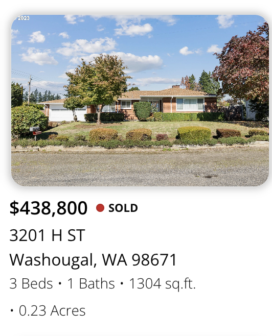 Front view of a single-story brick house with a well-maintained lawn and colorful trees on a sunny day.