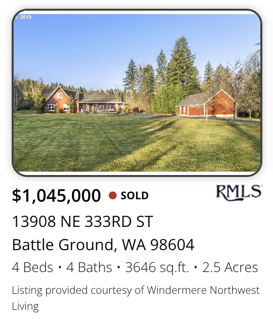 A large house with multiple sections and surrounding trees, sold by realtor Kelly Craig Graham, located on a spacious grassy yard in Battle Ground, Washington.