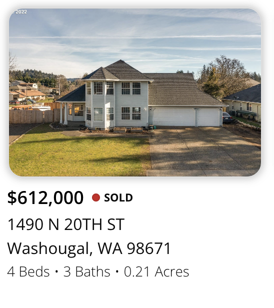 Front view of a two-story house with a large garage, situated on a property with a lawn and driveway, in Washougal, Washington.