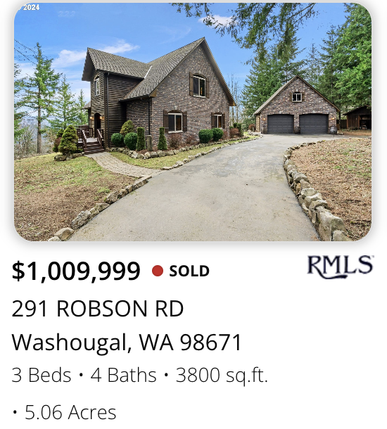 A brick house with a attached garage, surrounded by trees and bushes, with a curved driveway leading up to it in sold by realtor Kelly Craig Graham in Washougal, Washington.