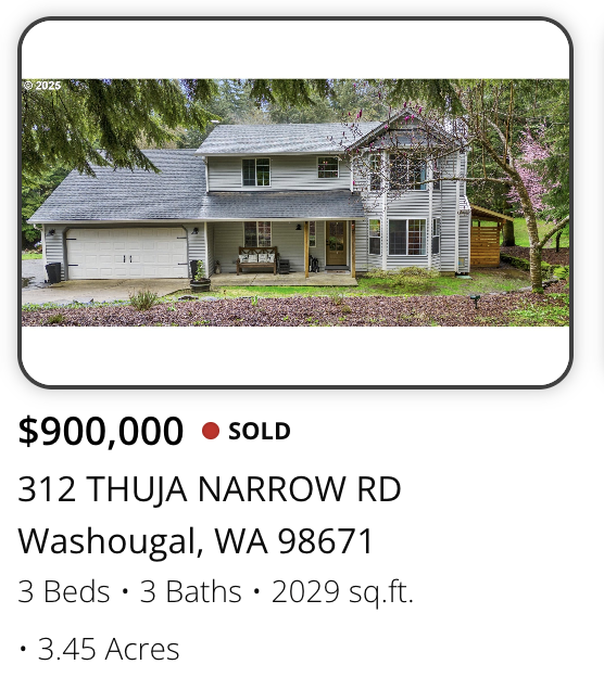 Front view of a two-story house with a attached garage, surrounded by trees and a lawn, with a porch and a bench outside.