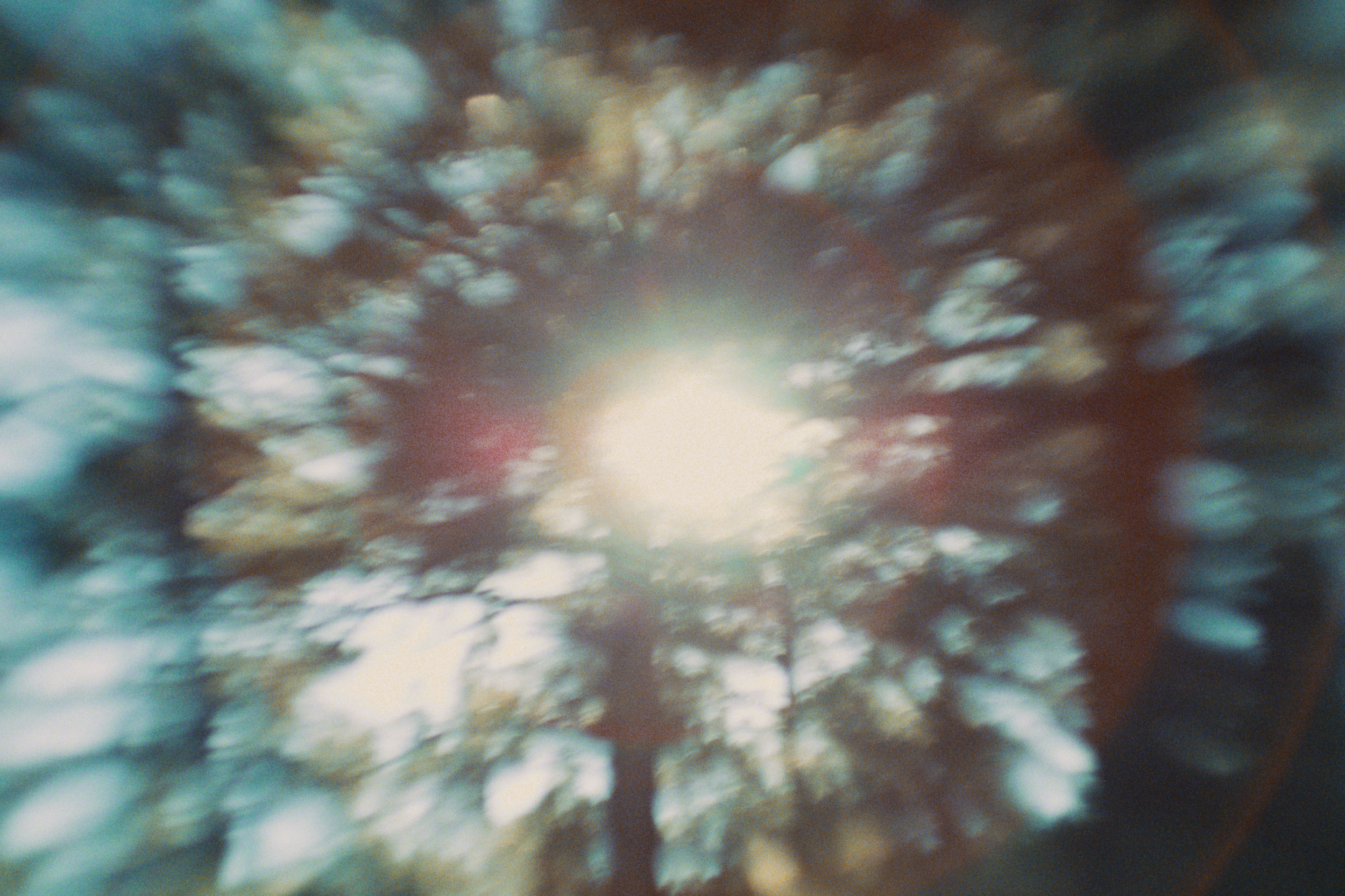 Blurred image of clouds in the sky with sunlight shining through.