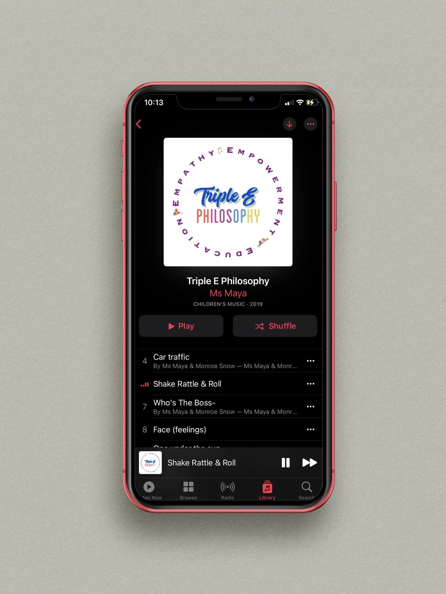 A smartphone displaying the music app with the album cover for Triple E Philosophy by Ms Maya, showing the playlist with songs like Car Traffic, Shake Rattle & Roll, Who's The Boss, and Face (Feelings).