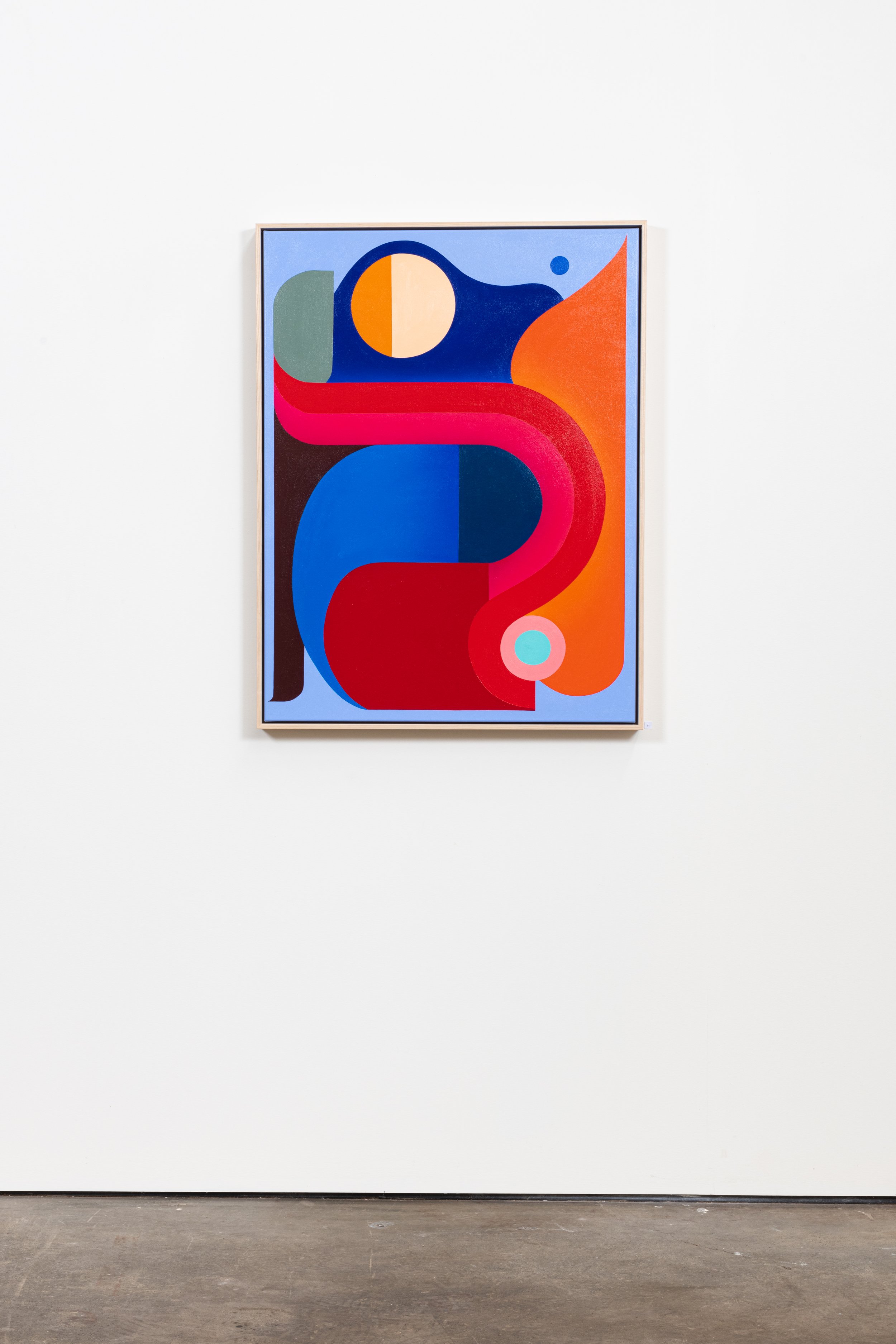 Abstract colorful geometric painting on a gallery wall with a white background and gray flooring.