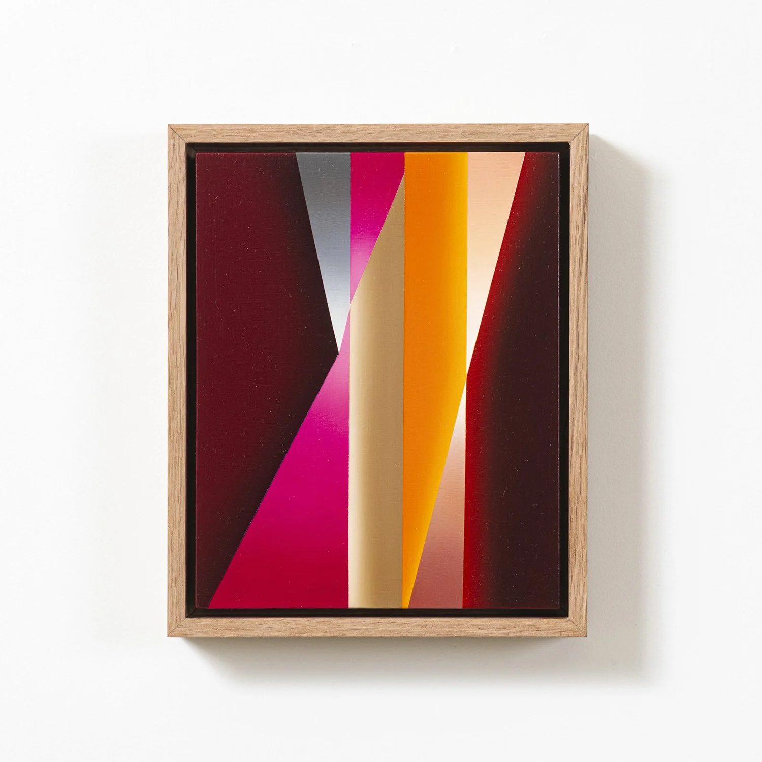 Abstract geometric artwork in a wooden frame with bold shapes and vibrant colors, including pink, orange, beige, and red.