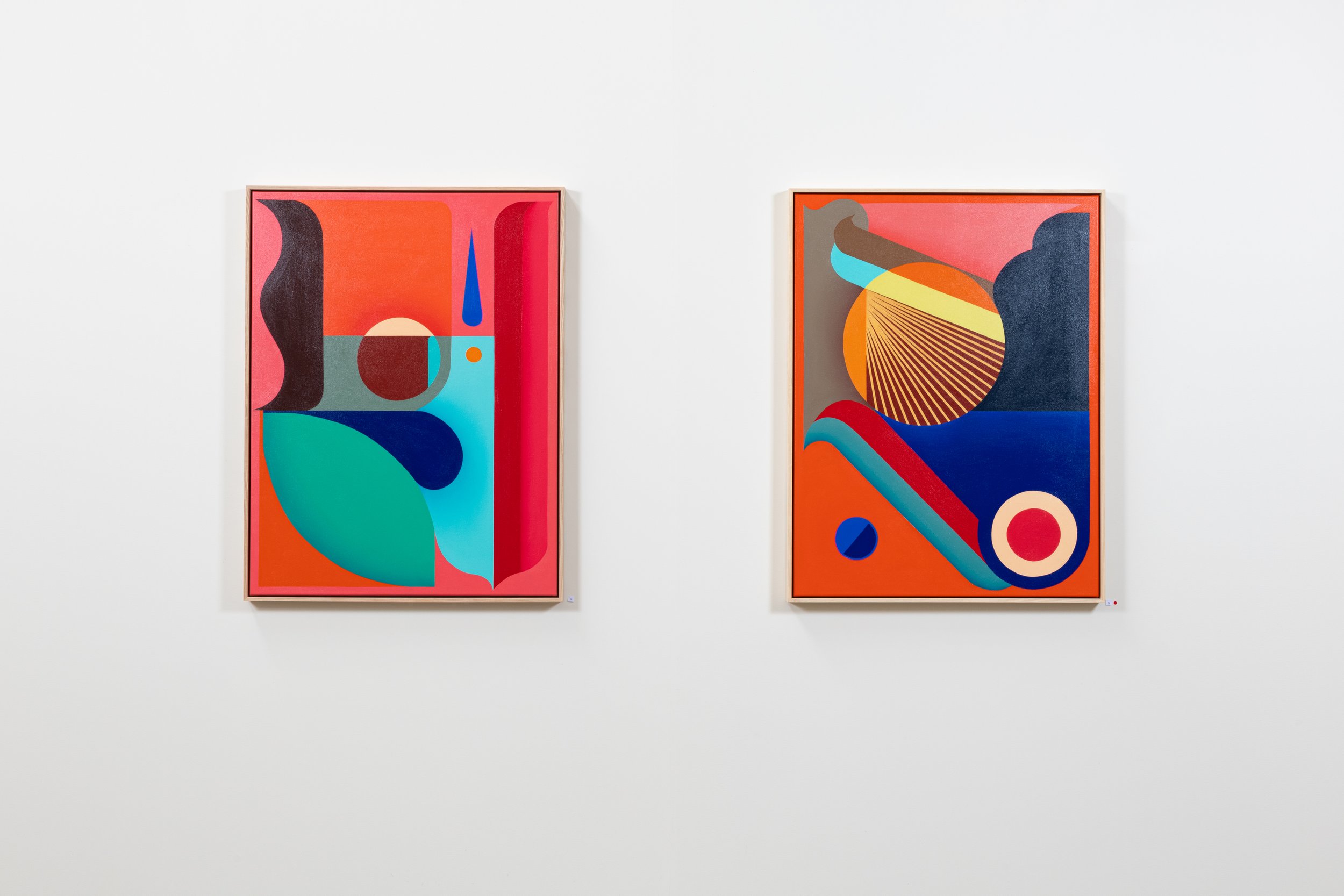 Two abstract colorful paintings with geometric shapes hanging on a white gallery wall.