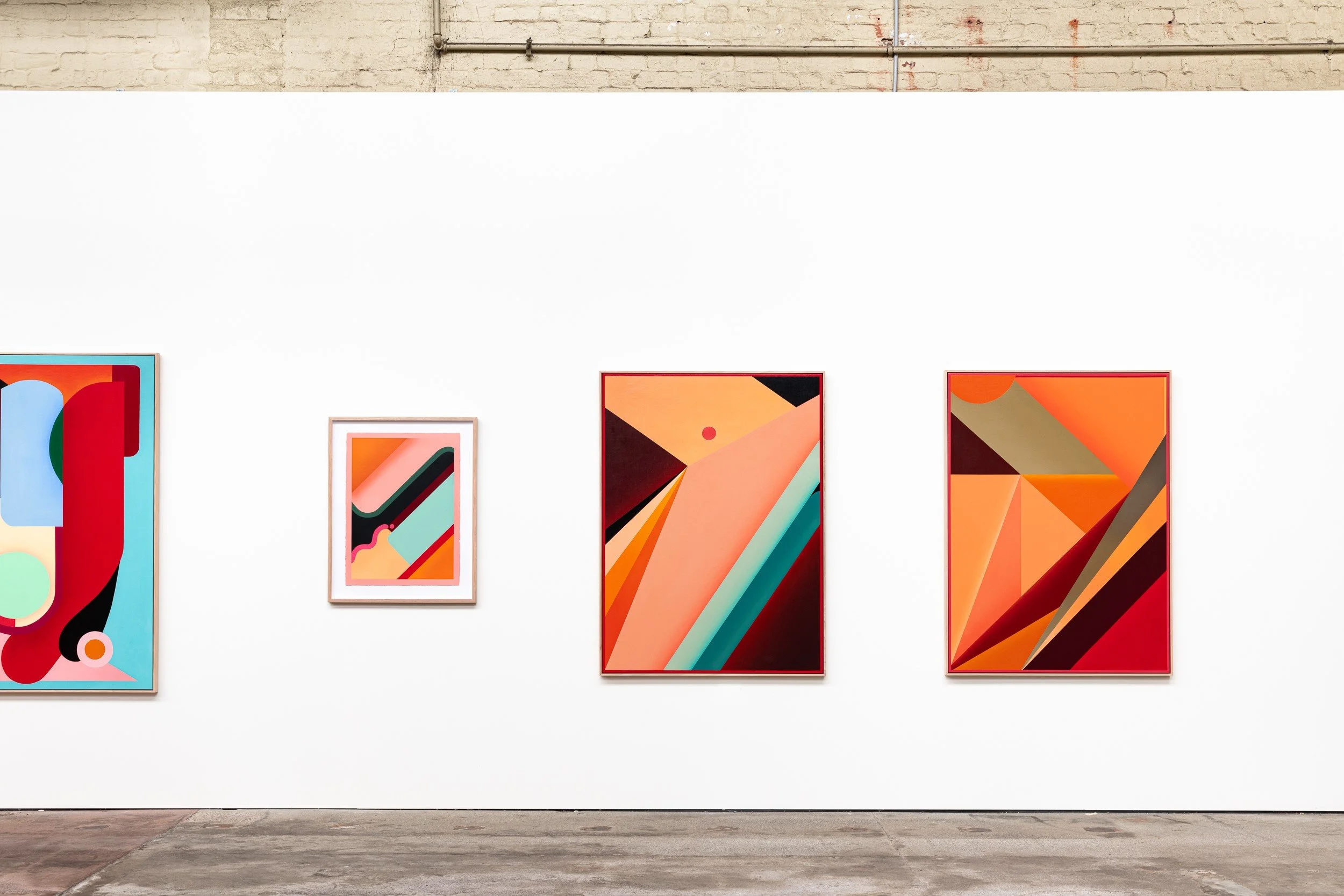 Four colorful abstract paintings hung on a white gallery wall in an art exhibit gallery.
