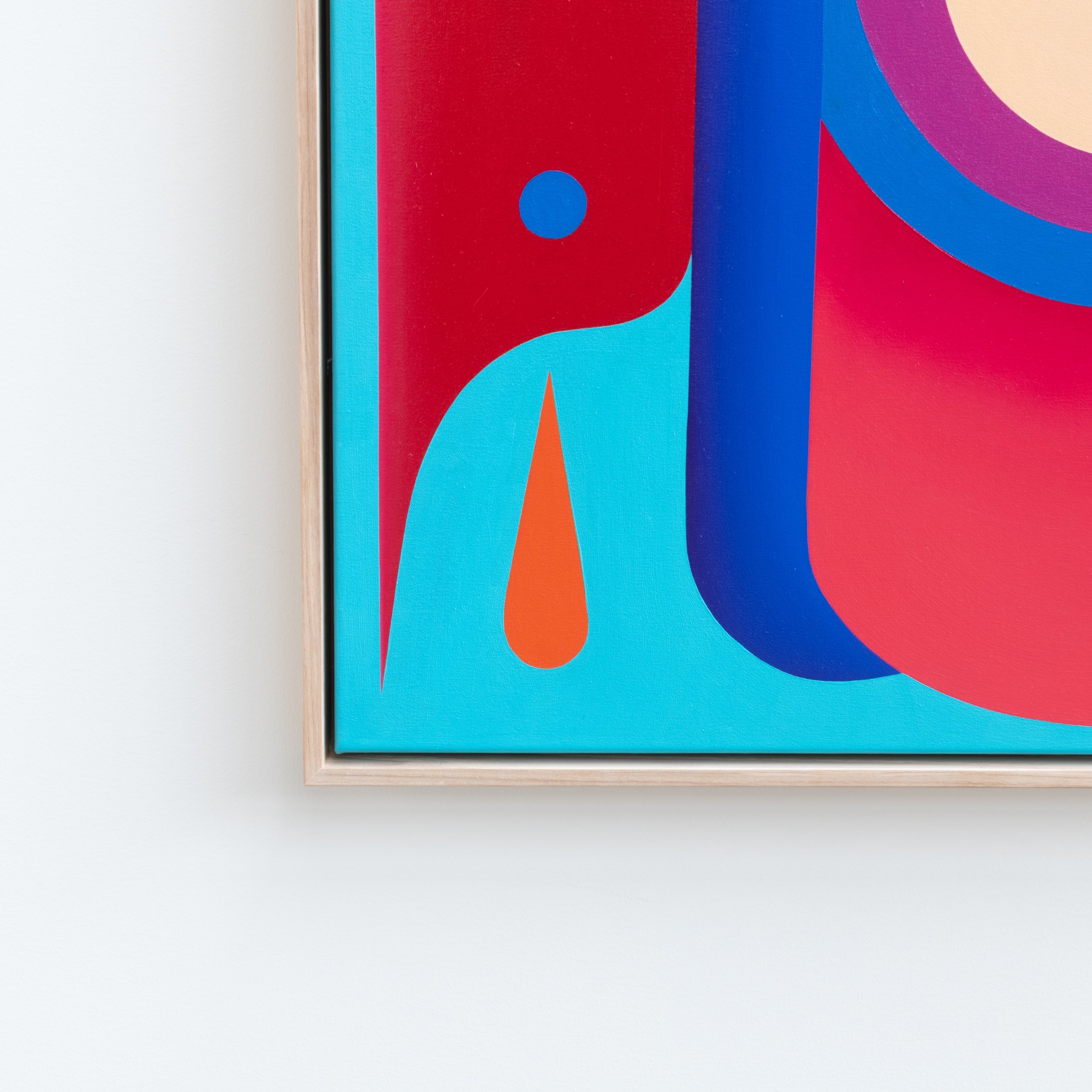 Close-up of colorful abstract artwork with red, blue, purple, and orange shapes in a white frame.