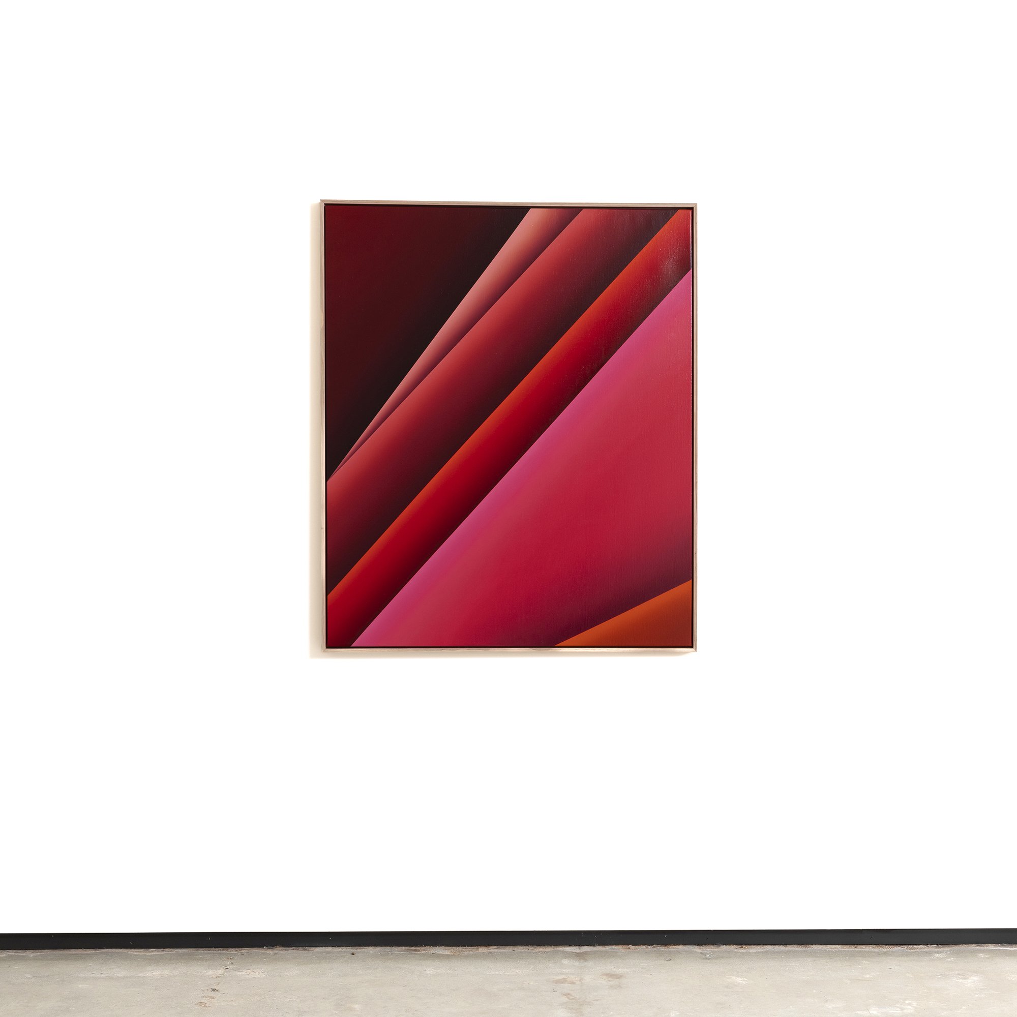 Digital artwork with red, pink, and black diagonal stripes displayed on a framed wall art piece.