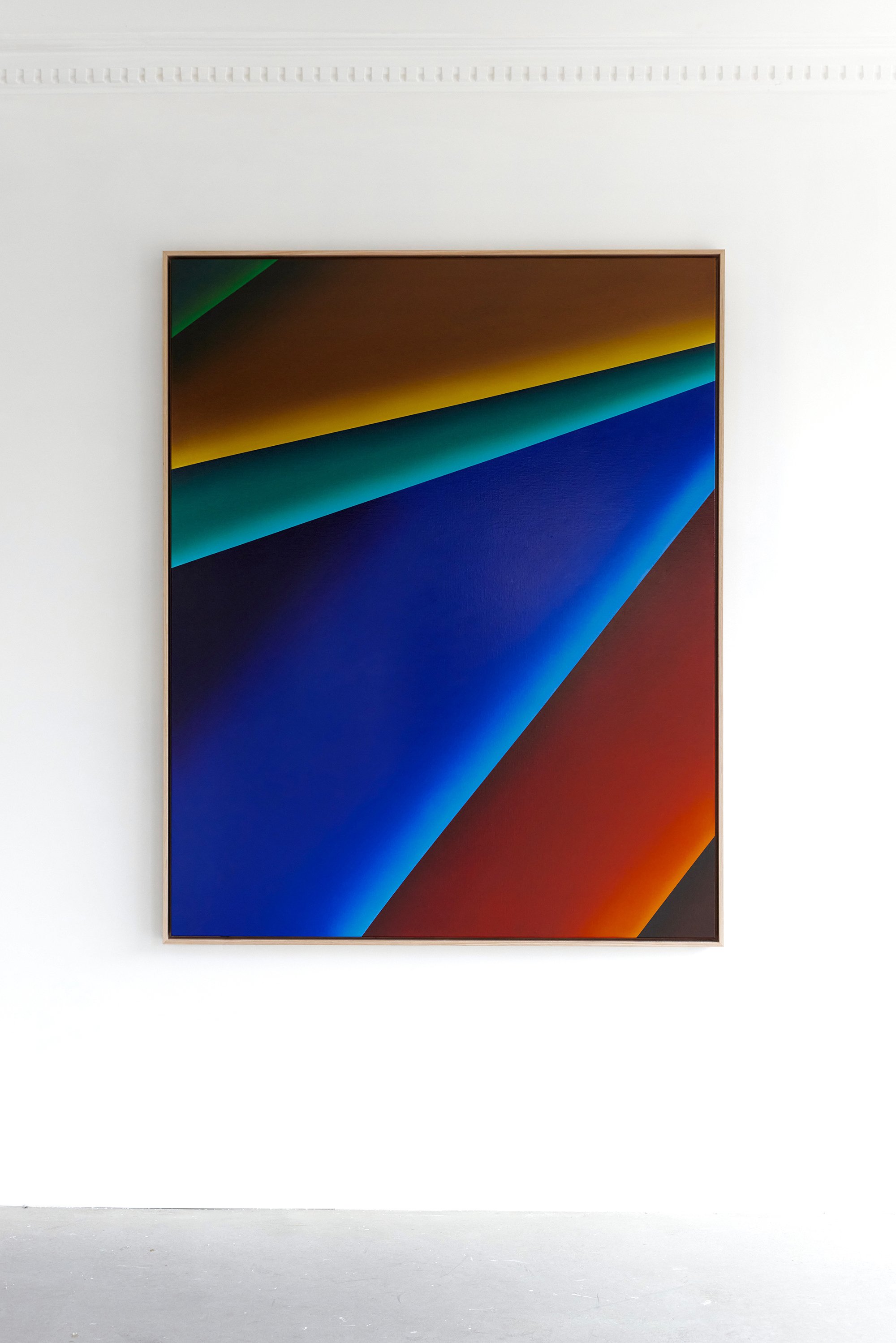Abstract artwork with colorful diagonal stripes on a white wall.