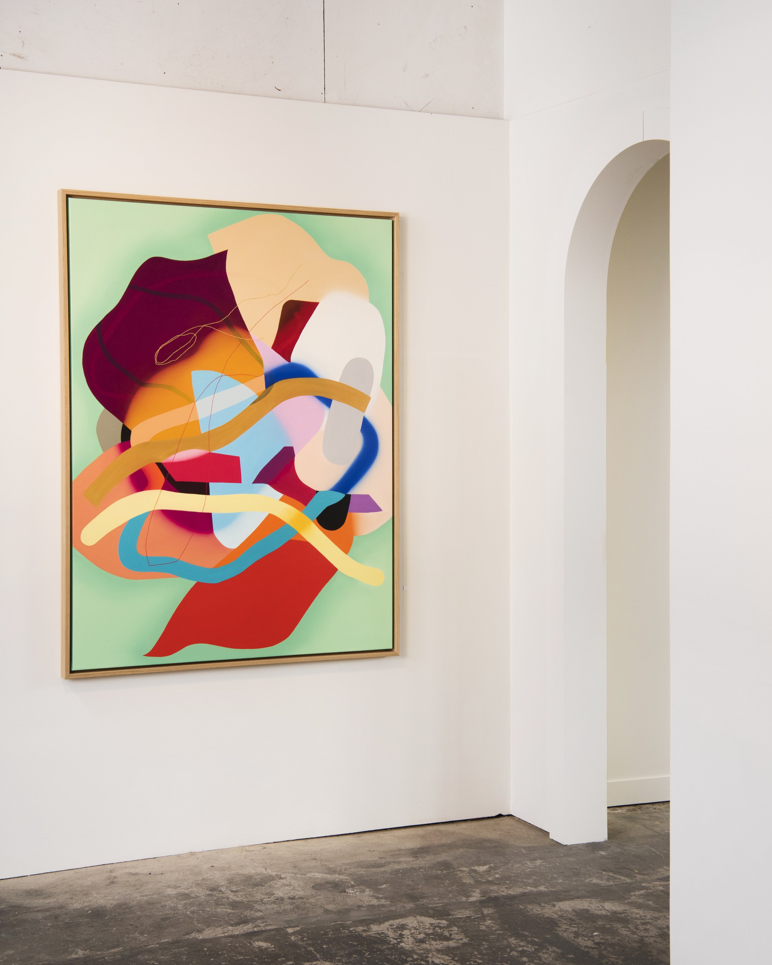 Abstract colorful modern art painting with various shapes and lines displayed in a gallery