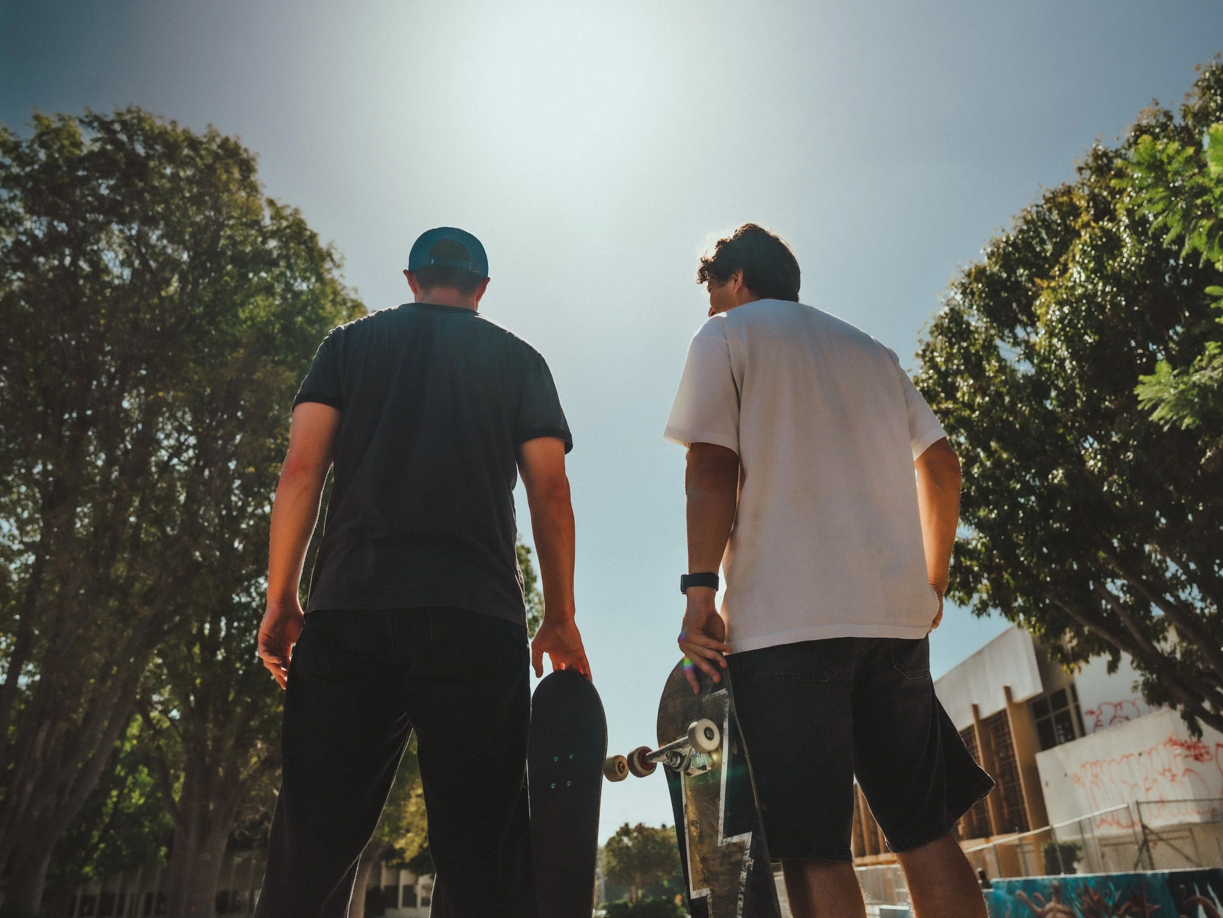 Brandon Loufas and Isaiah Rojers walking out of the skatepark at the West LA Courthouse skatepark, Los Angeles skate photography by Osy Ikhile
