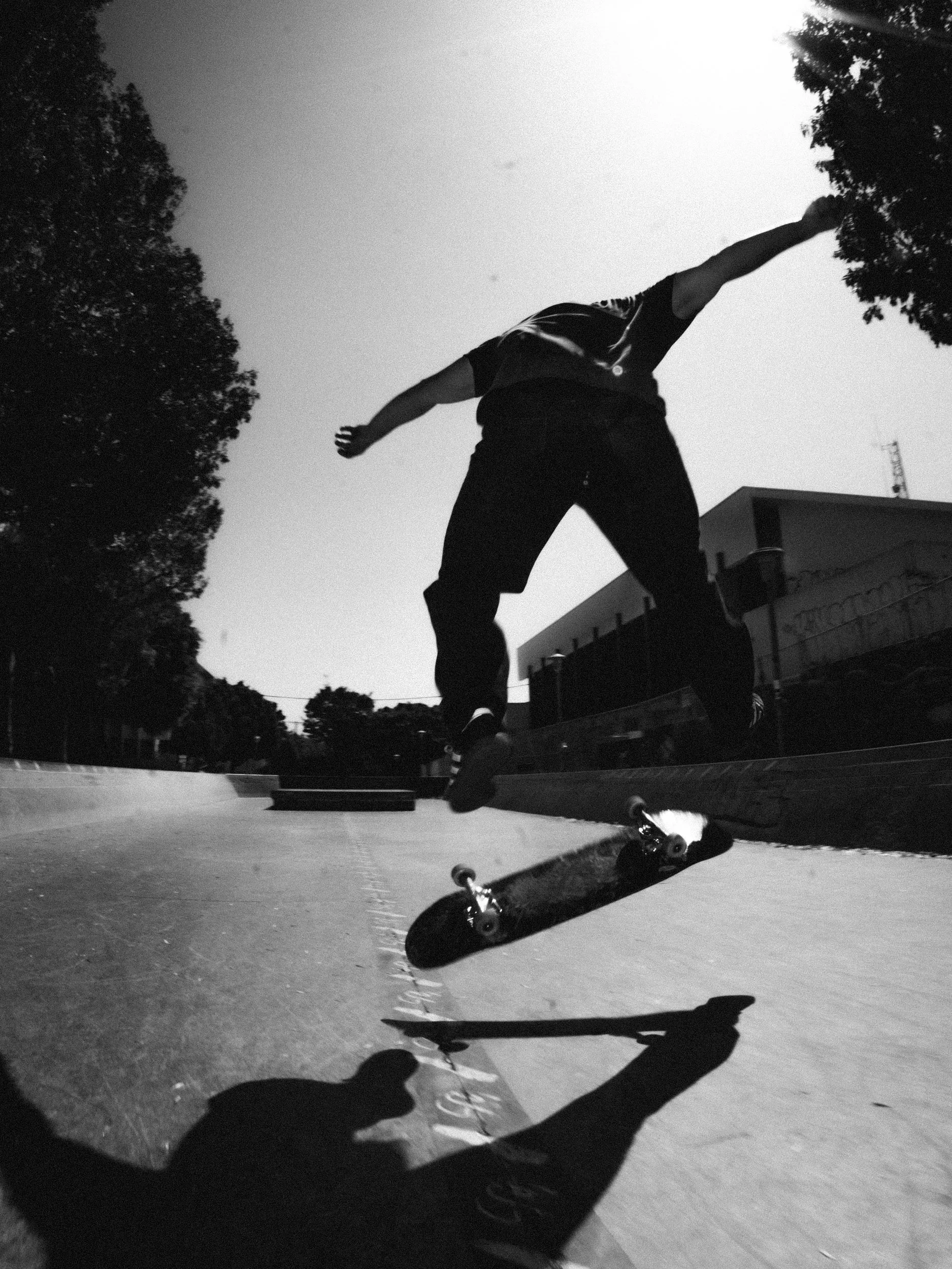 Black and white kickflip by Isaiah Rojers at the West LA Courthouse skatepark, Los Angeles skate photography by Osy Ikhile
