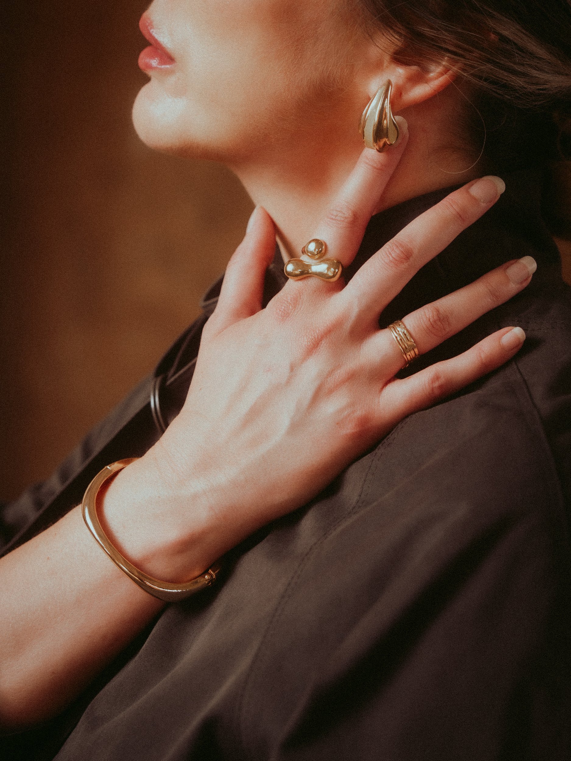 Detail of gold rings, cuff and earrings on Milanka Brooks, editorial fashion photography by Osy Ikhile, Los Angeles